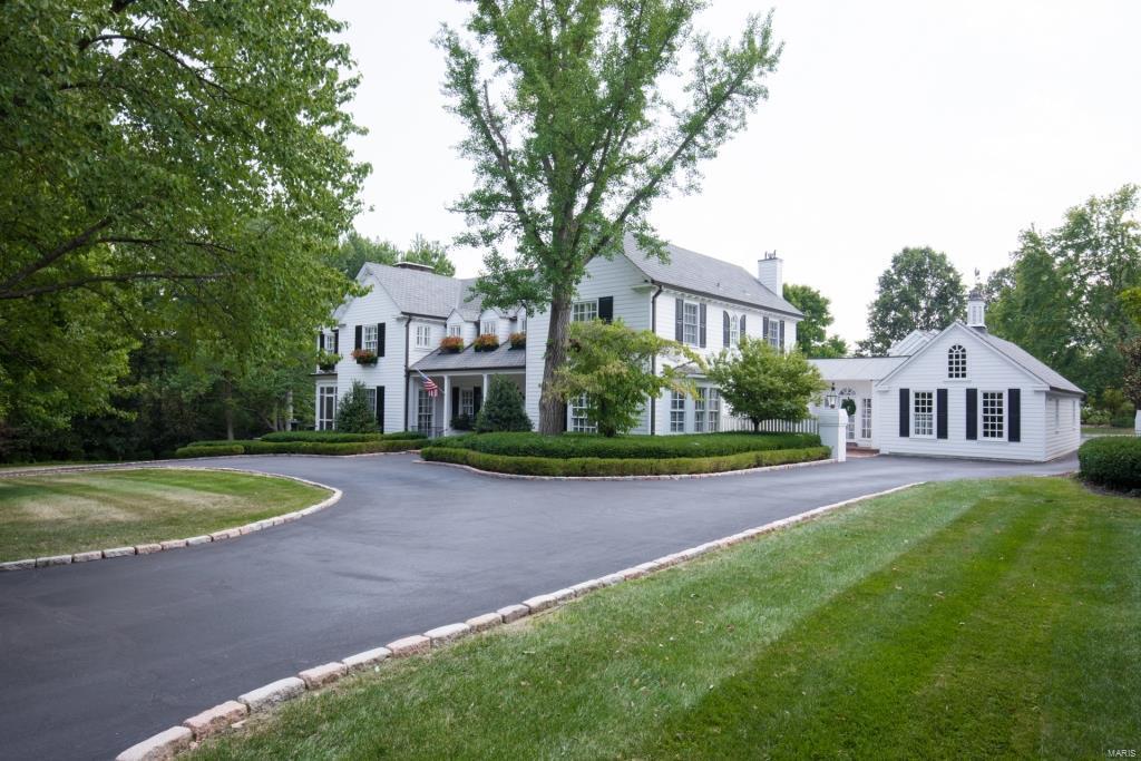 Stunning New England Colonial w/7000+/- sqft of living spc, situated on 1.86 acres (tax records incorrect). Ladue Schools! Grand Foyer w/wood floors; gourmet Kitchen w/custom cabinets, granite, custom backsplash; light & airy Hearth Rm w/gas FP. Formal Dining Rm w/custom built-ins, spacious Living Rm & incredible Game Rm w/custom barn. Beautiful staircase to 2nd Flr w/Master Ste w/luxury Bath w/heated floors, walk-in closet & Sitting Rm w/glass pocket doors & amazing curved windows. 3 add’l Bds, 2 Bths, Family Rm w/Powder Rm & wet bar complete 2nd Flr! Finished LL w/Guest Ste & full Bth. Highlights: O/S 3-car garage, zoned HVAC, sprinklers, alarm, 3 zone Beam vacuum, plantation shutters, outdoor lighting & landscaping. Relax outside on the screened-in porch, or on the teak wood deck & admire the enormous level yard, or just take a stroll through the park-like neighborhood! Great location – close to restaurants, shops, hospitals & schools. Easy access to hwys.