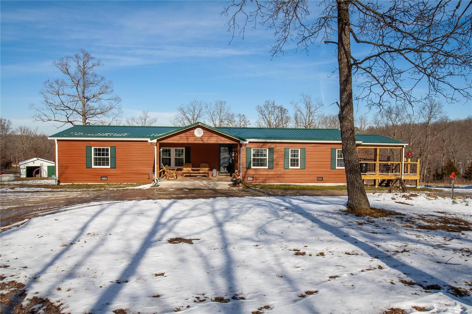 Secluded 3 bed, 2 bath home with multiple outbuildings situated on nearly 29 acres! This home offers an adorable covered front porch, incredible HUGE covered deck including a ceiling fan, PLUS an awesome sunroom! Walking into the home, you'll notice a cute entryway leading into either the spacious living room or the formal dining room. The gorgeous kitchen provides a breakfast bar, center island, stainless appliances, pantry, pretty backsplash, & plenty of cabinet/counter space. Off the kitchen is an additional dining area that adjoins to the living room & also provides access to the sunroom! The spacious master offers a walk-in closet & its own private bath! Additionally, there are 2 nicely sized guest bedrooms, a full guest bathroom, as well as the laundry/mudroom that leads out to the deck. Outside the home, there are multiple outbuildings for storage, hobbies, & vehicle/UTV parking. The land is perfect for ALL of your outdoor/recreational needs or desires! Schedule your showing!