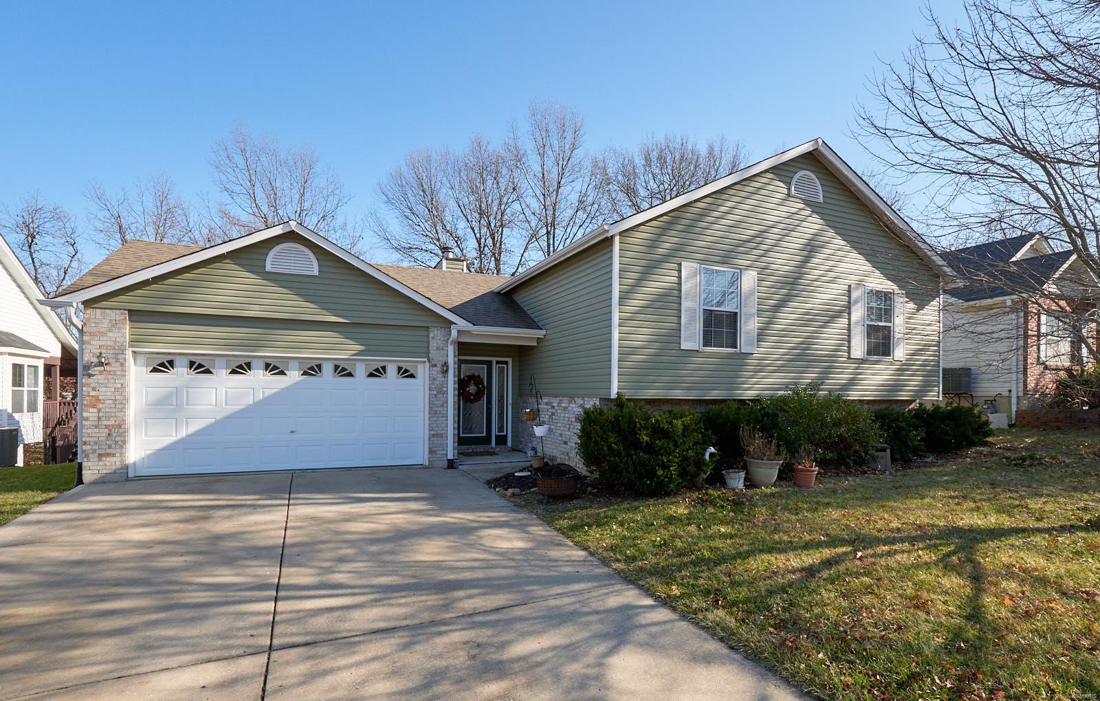 Wonderful 3 bedroom, 2 ½ bath split foyer home in a fantastic St Peters neighborhood.  A covered porch welcomes you into the large foyer.  Up a short flight of stairs, you will find the spacious living room with new carpeting and a large window with rays of light cascading in past a beautiful maple tree.  Next is the kitchen with an island and updated cabinets extending into dining room providing plenty of storage space.  Continuing to the large master bedroom you will find a full master bath.  Two additional bedrooms and a guest bath complete this level.  On the lower level you will discover a fantastic family room with a cozy gas burning fireplace.  Through the french door is a patio and wooded private rear yard perfect for entertaining.  An office and half bath complete this level.  Off the entry foyer is an oversized two car garage with an additional work area that completes this home.  Some new carpeting 2019, New Roof 2016.  Solar Panels have been added for energy efficiency.