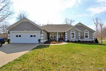 Updated home in beautiful Windwood Lake subdivision with secluded living on a large lot with mature trees.  This home has an Open Floor Plan with generous window space offering elevated views of the surrounding area.  The modern eat in kitchen features a seated island, new cabinetry with soft-close drawers topped by high end white fantasy granite.  New custom installed and stained 3/4" Oak Hardwood Floors in the kitchen, living/dining room and extend down the hall into the master bedroom and walk-in closet.  The Master Bedroom has a generous amount of windows, & a tray ceiling, a newly updated bath with a double vanity topped with Carrera marble, and a separate custom shower with mosaic accents.  The home also features vaulted ceilings, stack stone fireplace, screened porch, separate large deck, 2nd living room in walk out basement, bonus room/study, nice landscaping and a beautiful lawn. Fresh paint inside and out, custom lighting and an additional 1,200 sq. ft. for Expansion.  There