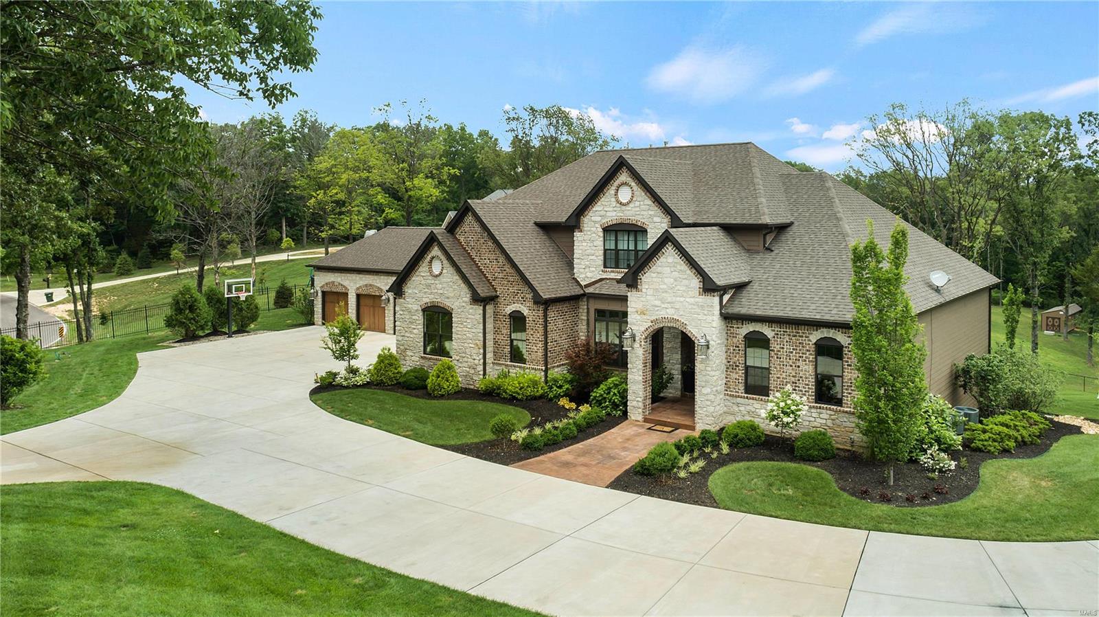 Exquisite gated home on 3.09 +/- ac & built in 2016, has a gated circle drive & 6 car garage. Home feat main floor master suite w/2 closets, double vanities, huge shower w/dual shower heads. Kitchen w/stainless appliances, gas range/oven, built-in microwave, wall oven, wine fridge, no touch faucet, HUGE center island, slate flooring & hearth room. Living room w/built-in shelving & wood floors has sliding doors to outdoor covered porch. Upper level has 4 large bedrooms and 2 full baths. The finished walkout lower level features a large rec room and bar, batting cages, full bath and plenty of room for storage. The crowning gem of this house is the backyard oasis, featuring a large saltwater pool, hot tub, covered cabana/ bar area with tin walls and wooden ceiling, with grill, gas cooktop, storage, & TV's. The entire yard is serviced by the water sprinkler. 3 zoned HVAC units, continuous tankless hot water heater, full security system & lights, 11 TV'S stay with the home and 5 fireplaces. Additional Rooms: Mud Room