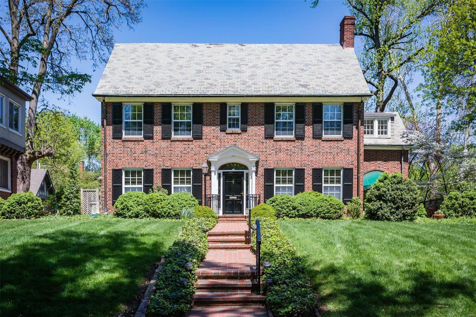 Follow the beautiful brick walk to this stately 2 story Georgian Colonial on a large tree-lined corner lot. As you enter, there is a light, airy feel with bright walls, large windows, and gleaming hardwood flooring. The impressive library offers walls of custom shelving, a large bay window and wood burning fireplace. French doors lead to the lovely back yard that is sure to be the envy of the neighbors. If you need to get in out of the sun, but still want to enjoy the fresh air, flowering plants and trees, step into the 15x9 screened-in porch located off the spacious living room featuring a handsome gas fireplace. The updated kitchen has a granite peninsula, custom cabinetry and stainless-steel appliances. Detached two car garage. Minutes from the Delmar Loop with specialty shops, restaurants, entertainment, galleries and more.