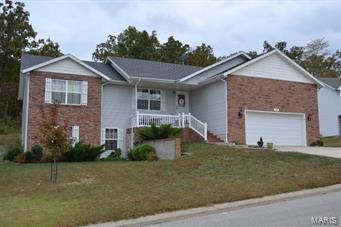 LOTS of space at a GREAT price!! This four bedroom, three bathroom home sits over a FULL finished, walk-out basement with lots of space! Property is located in the very popular Woodland Hills subdivision in the Waynesville School District. Step into the elegant living room with hardwood floors, cathedral ceilings and gas fireplace perfect for entertaining. The dining room and kitchen both feature hardwood floors, stainless steel appliances with French doors that access the back deck. Enter the master bedroom with it's cathedral ceiling, HUGE walk-in closet and features a separate shower with two seats, jetted tub and double vanity sinks. The basement features a second master suite, a bonus room, carpeted family room. Other features of the home include a 20x20 stained deck with seating, huge linen closet and patio.