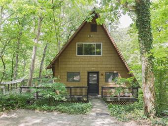 When you come home after a hard day’s work, do you want to feel like you’re leaving the cares of the world behind as you enter the cool green forest, then this UNIQUE A Frame with wrap around deck is for you. It's like you're living in a gigantic and civilized tree house, but with air conditioning and three full bathrooms! During the summer, you won't see the neighbors, just beautiful trees and wildlife.  Deer, groundhogs, squirrels & woodpeckers are just some of the wildlife you will see according to the owners. Some other cool things include  the mantelpiece made from a tree on the land. There are multiple doors to the deck that  extend to three sides of the house, feeling like a natural extension of the indoor space whenever the weather is nice. Laundry is on the main floor, but could easily be relocated to the basement if you prefer. Four bedrooms give ample space for your family. Open floor plan yet different floors for privacy gives the best of both worlds. This is a must See!