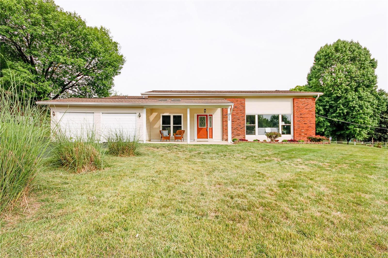 This beautiful multi-level home located on a large level lot includes 3 bedrooms with the second bedroom housing its own full bathroom.  3 1/2 baths in total, updated kitchen, newer roof, A/C and furnace.  Large living room and dining room combo featuring 12' ceilings.  Entertain on the covered porch with skylights or BBQ on the deck.  Enjoy maintained free vinyl siding.  This home also has zoned heating & cooling systems & lots off additional parking surrounding 2 car garage.