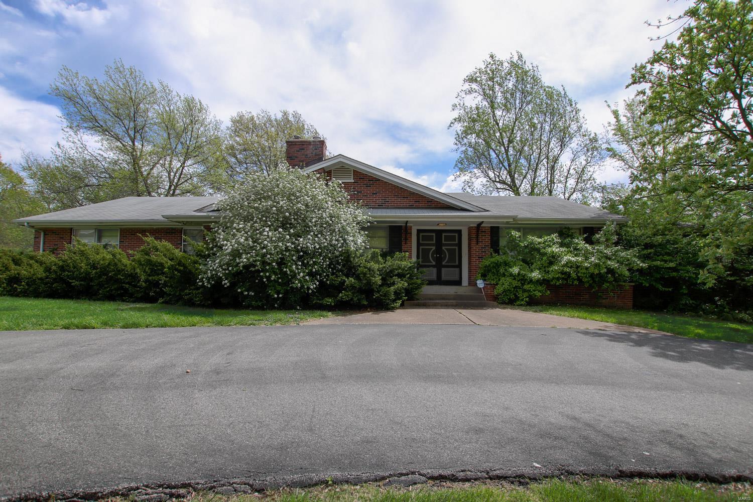 Home sold AS-Is...Seller to do no repairs. Large mid-century rambling ranch home in Ladue Schools on 1 Acre lot. Features large kitchen overlooking back yard. Kitchen is open to breakfast room & family room. Family room features large windows, recessed lighting & wood burning fireplace. Separate dining room attached to kitchen, home is perfectly set-up for entertaining. Main floor laundry room off of kitchen as well. Awesome center hall floor plan with 4 bedrooms. Each bedroom is designed w/direct access to its own bathroom. Hardwood floors covered with carpeting likely throughout most of the home. Large living room w/lovely wood burning fireplace. Loads of parking w circle drive & 4-car garage w/separate drive, very large unfinished walk-out basement with 1/2 bath, if finished could create up to 5,000 total square feet of living space. Walking distance to elementary school and close to shopping, movies, restaurants & so much more. Truly a large diamond in the rough. Private ownership. Additional Rooms: Mud Room
