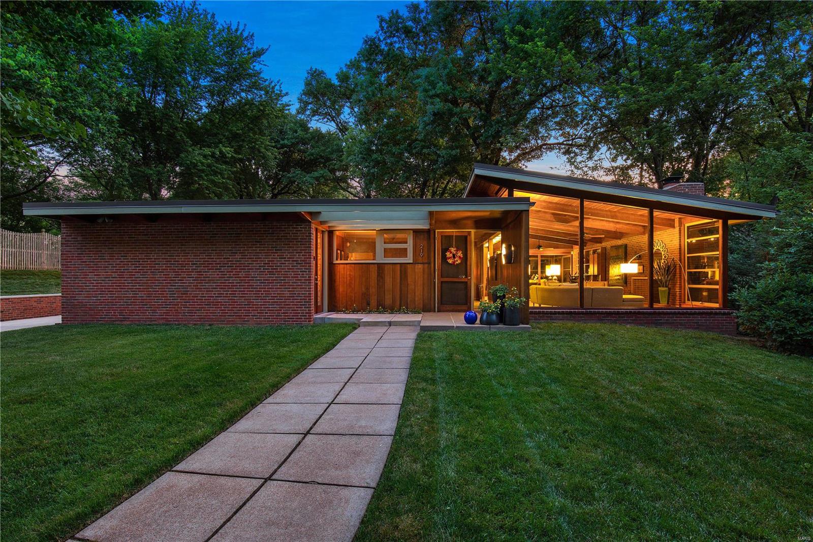 The Harry Hammerman House, which is included on the National Register of Historic Places, is a true marvel of significant MCM architecture in St Louis. This important mid-century masterpiece has been completely renovated and features new walnut flooring, expansive floor-to-ceiling & clerestory windows, vaulted ceiling with coved lighting, wood-burning fireplace, and deep, private ¾ acre lot. During the complete renovation, the home was enhanced & expanded with a kitchen addition and an oversized 3-car garage. Impeccable kitchen with granite counters, backsplash windows, Bertazzoni gas stove with pot filler, Thermador oven and warmer tray, Bosch refrigerator, and Fisher & Paykel 2-drawer dishwasher. Primary bedroom suite with a luxury bath featuring a soaking tub, walk-in shower & dual sinks. All newer systems, including Geothermal HVAC, within a fantastic historic shell! Garage and screened porch floors have new epoxy, nonslip coating. Additional Rooms: Mud Room, Sun Room