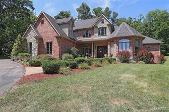 Beautifully landscaped home on 3 acres in Touchdown Estates.  Large circle drive with double door entry.  Foyer 9x15.6 with hardwood that leads to a 2 story living room and dining rooms.  Three fireplaces in living room, hearth room, and see through in large master suite leading to master bath.  Custom walk in closet (8.2x12.5) whirlpool tub, separate shower, double vanities with make up area.  Large center island in the kitchen with bar that seats four. Viking gas downdraft cooktop and Kitchen Aid appliances.  Granite countertops.  The hearth room opens from the kitchen with a fireplace and vaulted ceiling with natural wood.  Carpet in office/den and master bedrooms was installed in 2017.  Three zone heating and cooling.