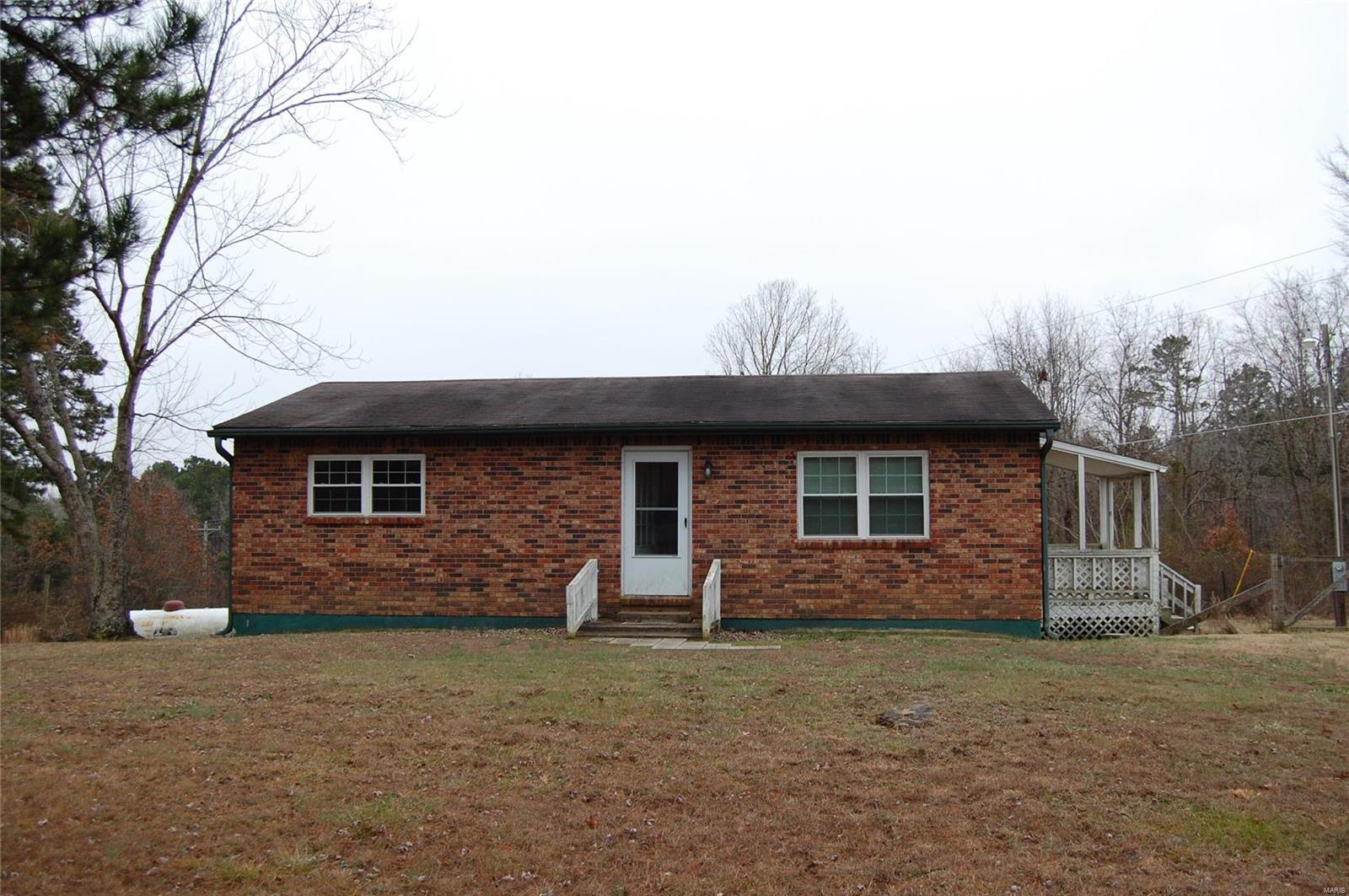 Cute Brick, 2 bedroom, 1 bath home with full unfinished walkout basement and deck on 1.20 acres m/l just outside of town.
