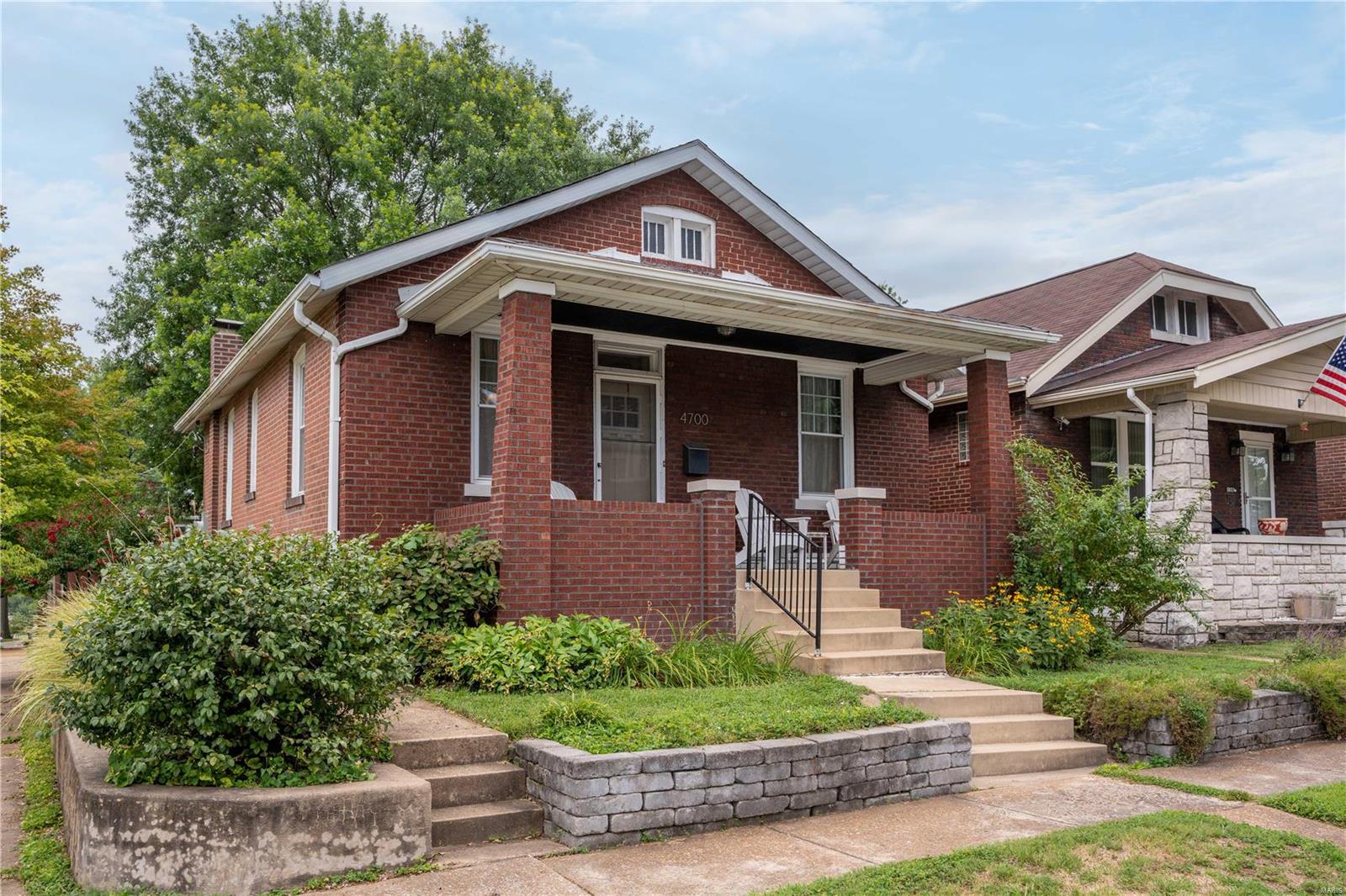 Est 1926 This buttoned up brick bungalow sits above the street on a corner lot with raised garden beds & a stone retaining wall that wraps the property & leads to the street accessed oversized garage. The porch perch is a perfect respite for enjoying passers-by & relaxing on spring & summer evenings. Inside you'll find the original details & craftsmanship in tact from the sweeping ceilings to the warm wood floors & mill work throughout. Not to mention the gorgeous built-in pantry in the eat-in kitchen or the original iron glazed tub & honey-comb floor tile in the full bath.  Add to that a true linen closet & updated vanity & cabinet & you have storage galore. The living/sitting rooms are excellent sizes to interpret for a combination of uses, whether work, lounging, learning or play & the quiet bed off the back makes for restful nights. New steel & Tigerwood deck is built to last & a mature trees cast a canopy over the shaded yard where landscaping abounds. New AC condenser & coil 7/22