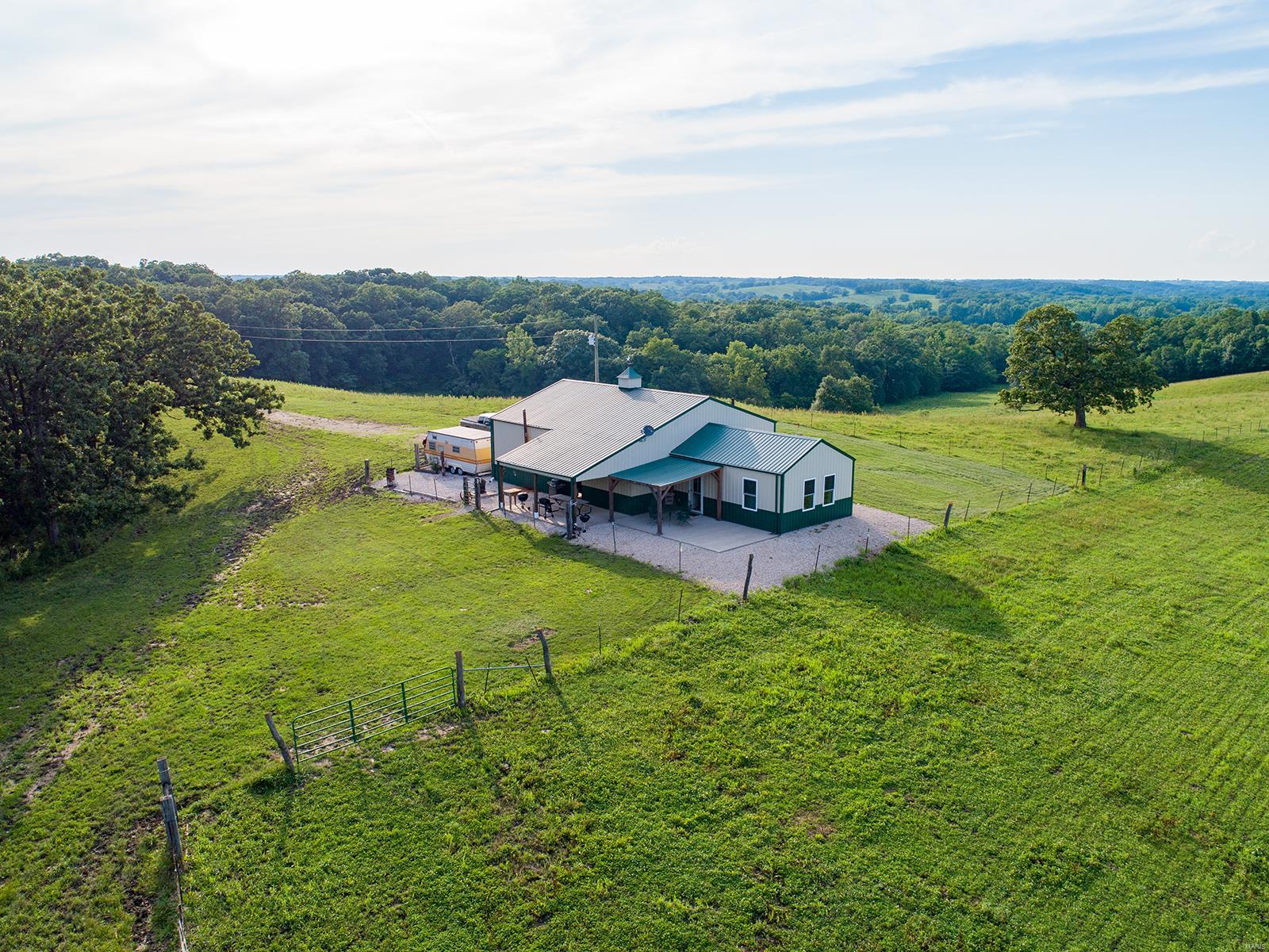 Check out this unbelievably nice cabin/house and 327 m/l acre property in a big buck country! This property would make a great residence or hunting camp.  Tracts of this size don’t show up on the market for sale very often in Adair County Missouri! This tract is located in some of the best deer habitat that North Missouri has to offer. This farm has produced a 182 inch giant!  Everything about this home is incredibly well done. The 940 sq ft. approx..  House has all metal siding and roof for low maintenance. A pretty 12x20 front porch with wood posts makes a nice place to watch the sunset. A large attached 882 sq ft. approx.. garage will hold all the toys. The heavy timber wood  interior is stunning and has a wonderful outdoor feel!   A beautifully finished home/cabin, big buck history, food plot areas, tillable make this a true turnkey property. This is the ultimate North Missouri tract in monster buck country, don’t miss out!