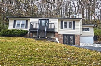 Looking for a beautifully updated home located in a quiet picturesque neighborhood? Look no further. Welcome to 1311 Lakemount, a lovely home in a private lake community that you can soon call yours! This home has countless features that will grab your attention.  The sprawling wood floors, fresh paint, and eye-catching clean and crisp exterior are some elements that will excite. The kitchen is absolutely stunning with glowing white cabinetry, stainless steel appliances, and natural light illuminating the space. Equipped with ample counter space for cooking and entertaining, the kitchen is sure to be a favorite place to hang out! The lower level offers additional living space with a bedroom, a full bathroom, and a place for couches and recreation. Double doors to the driveway are an added perk. Come quick, grab your agent, and stop in to see what all the hype is about!