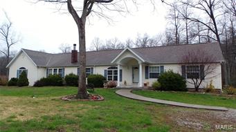 COUNTRY LIVING, plus a POND!  This 2414 sq ft, 3 bedroom 2.5 bath home sits on 5.31+/- acres.  As you enter the front door, you'll be in the living room.  Go to the left and you'll pass through the dining area.  Next, the floor plan opens up into the kitchen, breakfast room, hearth room and great room. The eat in kitchen features appliances that will stay, a center island/breakfast bar and a beautiful wood burning fireplace.  The great room has vaulted ceilings, stairs to the lower level and steps out to the private deck.  The oversized master suite features a double bowl sink, whirlpool and sep shower.  There are two more bedrooms and 1.5 more baths.  Main floor laundry is a plus.  On the outside,  you'll have two outbuildings and a shed.  The only thing missing is YOU!