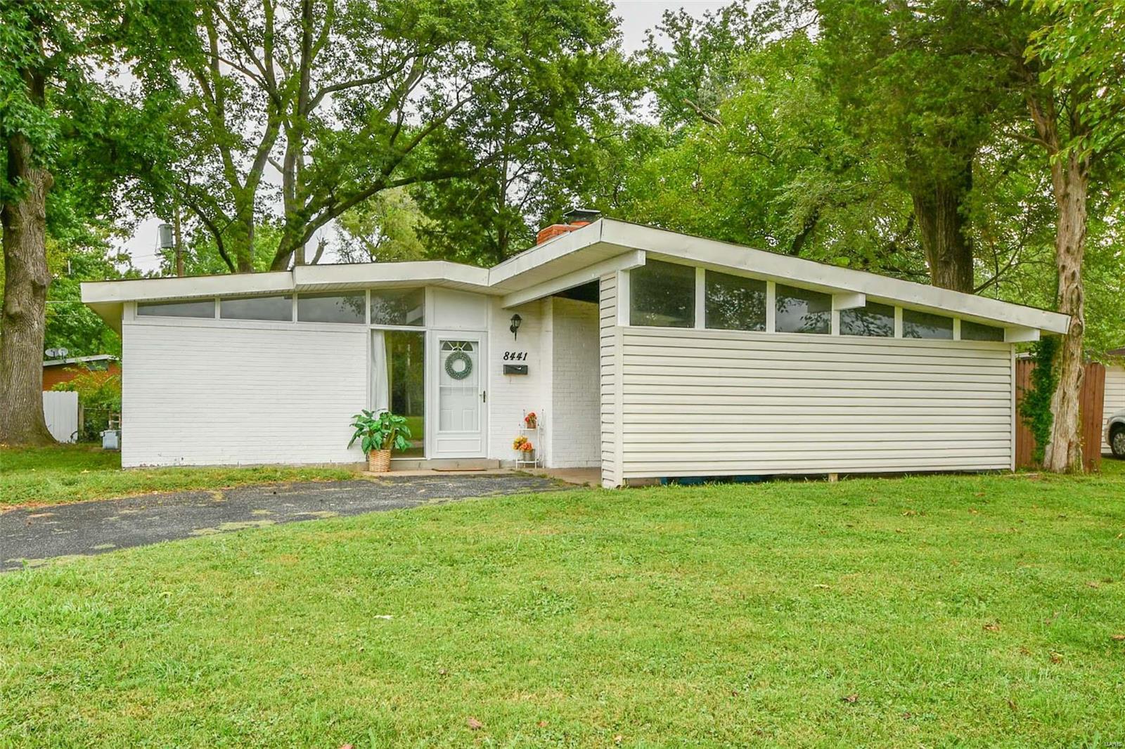Why pay rent when you can OWN a 3 bed, 2 bath home? This fabulous, mid-century modern bungalow is the perfect starter home or addition to your investment portfolio for a quick flip! Newly renovated homes nearby, just like this one, are selling for over $100,000. This home is priced with instant equity in mind. You're sure to adore the vaulted living room with a wood burning fireplace, mantle, and sliding door that walks out to the patio and a huge, level, fenced yard-complete with a pet door. Enjoy an updated kitchen featuring a sleek, modern backsplash, new countertops, and breakfast bar. A main-floor laundry room, with an attached folding table, makes chores a cinch! 2 spacious bedrooms are served by the full, hall bath. Everyone loves a generous master bedroom with ample closet space and an en-suite bathroom! Washer, dryer, refrigerator, stove, and microwave-all included! Prime location-just across the street from Frostwood Park and the City of Berkeley Municipal Pool. Welcome Home!