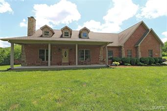 The hard to find has been found- land! This custom built home sits on almost 9 acres & is private yet minutes from I-55.  Covenants allow shops & horses! Home is in excellent condition & has wood burning fireplace, wood floors, vaulted ceilings custom pecan kitchen cabinets, large breakfast bar & walk-in pantry. Master suite opens to the covered deck & also has an oversized walk-in closet. Bedrooms are large as well & have jack-n-jill bathroom. Upstairs has a large 4th bedroom or could be used as game room or home office. Enter from your 3 car garage to an awesome laundry & mudroom with custom built-in cubbies. Full basement has high ceilings, walks-out & is ready to for future expansion. Either from evenings on your front porch or mornings on your covered deck you will feel the freedom & peacefulness of quiet living. Every view from the house is gorgeous with trees and privacy. Seller is willing to remove above ground pool if owner does not want it. $2,500 Carpet Allowance Additional Rooms: Mud Room