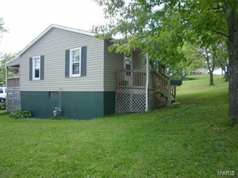 Small but packed with potential. Great for college students.  Don't rent when you can own and have students share the cost. The detachecd 2 car detached garage is deep and has room for workshop or storage.  Walk-out basment has laundry hook-ups and an additional finished bonus room.  Hall has linen closet, kitchen has lots of cabinets and pantry.  Back deck is covered and leads to garage.  Carpet is nice, Home has been freshly painted and has a nice yard that goes back to an alley.  Quiet neighborhood with easy access to Hwy 47 and just a block from the new grocery store!!.  Being SOLD  AS-IS!  Seller to make no repairs.