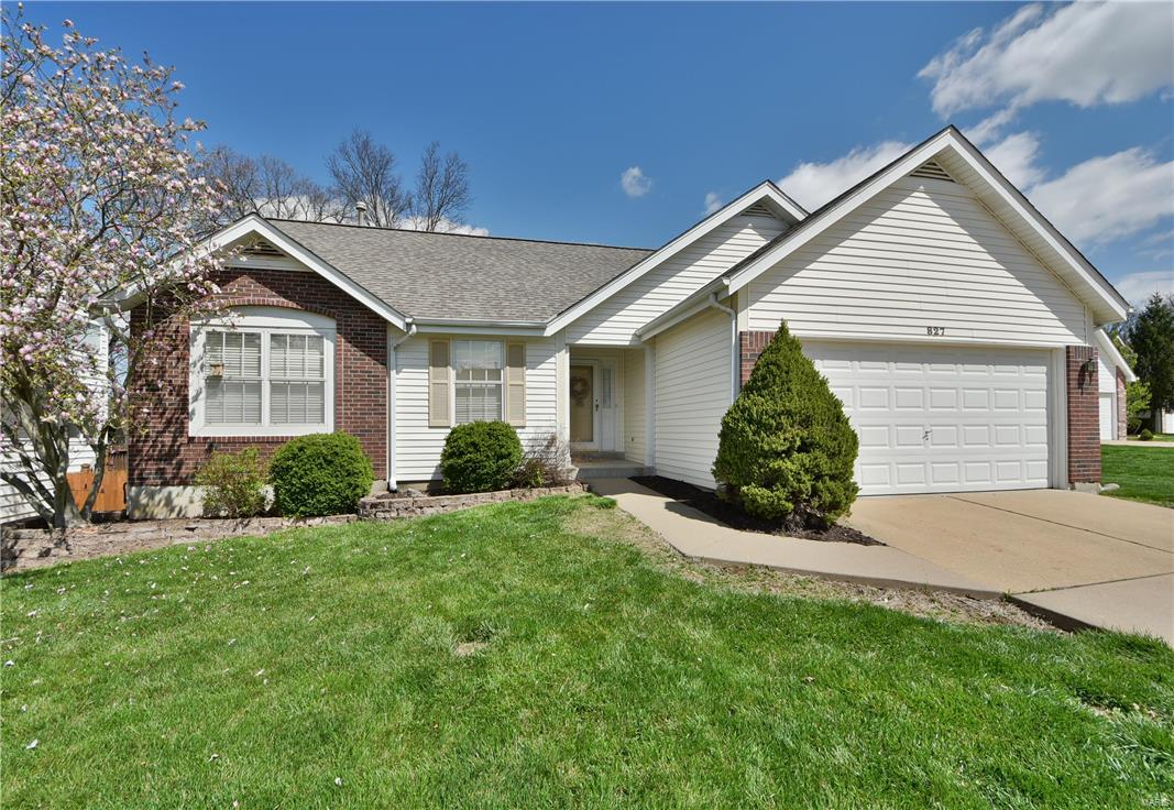 Everyone will instantly adore this spacious 3 bed/2 bath brick-front residence! The formal entry foyer welcomes you home & into the massive great room featuring a soaring cathedral ceiling, dual skylights, plant shelf & brick surrounded fireplace. The chef in you will delight at the inviting kitchen with ample cabinetry, pantry, decorative glass tile backsplash & convenient breakfast bar connecting to the adjacent dining room that offers bay-set sliding glass doors to the elevated back deck overlooking the large yard that backs to woods. Retire in style & comfort in the generously sized master suite that boasts another tall cathedral ceiling, double door entry, walk-in closet & luxurious private bath with jet tub & separate walk-in shower. The walk-out/look-out lower level has a rough-in bath & is ideal for finishing to your desired plan. Easy parking with the private drive & attached 2-car garage. Treat yourself with an Appointment Today!