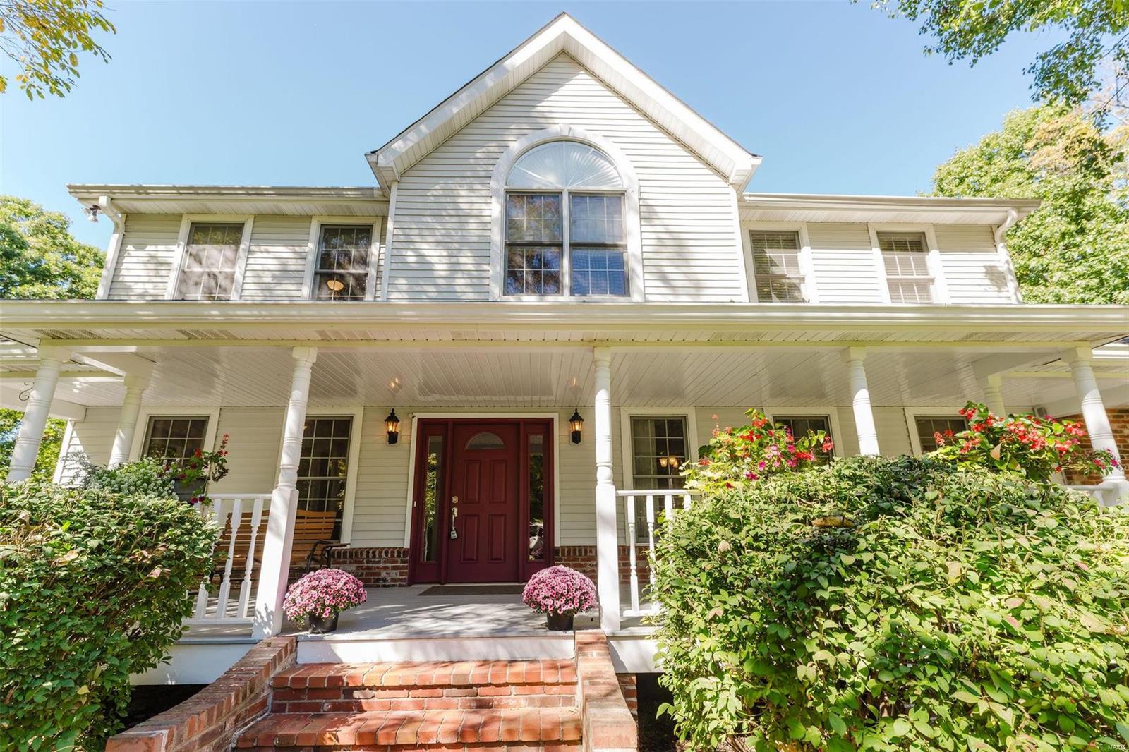 Be Home for the Holidays! Over 3000 square feet on 3 acres backing to woods in STL County! Well maintained! Step onto the lovely covered front porch, room to dine al fresco & find a spacious living room, dining room, office, kitchen, powder room & Patriot Sunroom allowing you to observe nature from fully climate controlled space. Kitchen has custom cabinetry, center island & pantry.  Enter Main floor Laundry room/mudroom from oversized 2 car garage! Upstairs find Primary bedroom with ensuite bathroom with double vanity, separate shower & soaking tub. 3 more spacious bedrooms & 2nd full bath. Lower level contains large finished area with 1/2 bath with rough in for shower. Large storage area, stairs to garage for easy loading. Outdoor living space with huge level yard, 2 patios & play area w/ rainbow playset, Shed & trails downhill to creekbed. Updated geothermal HVAC, low utility cost, newer roof! Property taxes incl. new water service to street, paid in complete 2029. Additional Rooms: Sun Room