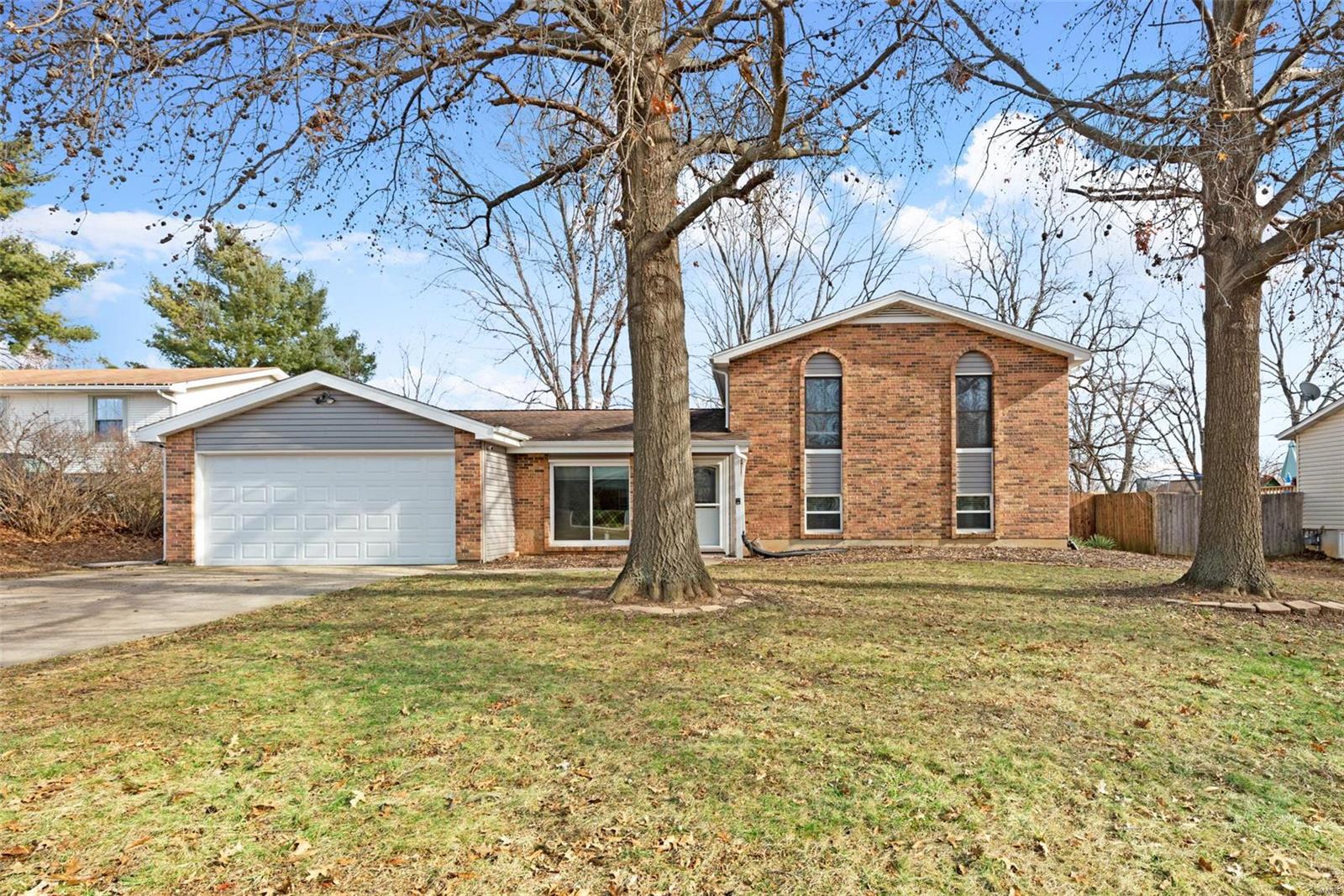 This Charming 4 bedroom multilevel home has everything you could want!  A kitchen that features upgraded espresso cabinetry with crown molding, granite counters tops, large pantry and gorgeous laminate wood floors. There is a separate breakfast room leading to the backyard and patio, and a large vaulted living room to finish the main level.  Upstairs there are 3 bedrooms and 2 updated full baths.  The master bath has an attractive shower surround and laminate hardwood flooring.  The lower level features a large family room with a wood burning fireplace and a 4th bedroom.  The brick front, vinyl siding  and mature trees give this home tons of curb appeal.  A large level, fenced backyard with a large patio will make your summer entertaining a breeze.  Close to shopping, restaurants and easy access to Hwy 70.  Subdivision amenities include a pool, basketball court and a lake with a walking path with a gorgeous view.  This one is sure to be sold in a hurry, schedule your viewing today!