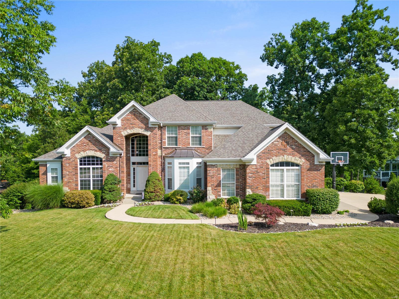 Beautiful exceptionally maintained 1.5 story in sought after Oaks of Andrew Woods. This private wooded lot backs to hole 17 on the prestigious Lake Forest Golf Course. The stunning architecture impresses from the foyer into the 2-story great rm. The main level master suite has a bay window overlooking the private backyard, bath w/ luxury shower & large walk-in closet. The main level also offers an executive style office, formal dining rm, a remodeled kitchen w/ quartz countertops, octagon hearth rm & stone fireplace. 4 total bedrooms w/ 3 full and 2 half baths. One upper-level bedroom has an ensuite w/ a walk-in closet. The other two bedrooms have walk-in closets & share a jack & jill bath. Fin w/out LL offers an extra family rm w/ fireplace. New roof, gutters & premium gutter guards in 2020. 2 new hvac systems in 2017, newer hot water heater, newer double convection wall oven, security system, inground sprinkler system. LSL lake amenities w/ EZ access to I70, I64 and 364!