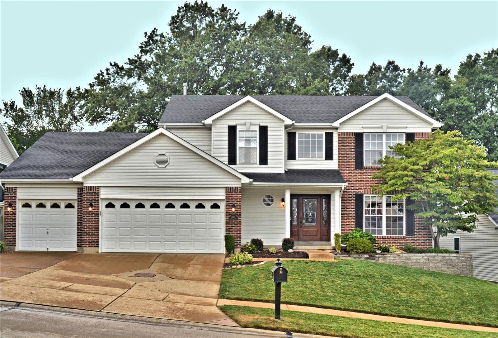 Walk past the covered porch and lead glass entry, wood flooring welcomes you into the 2-story entry foyer.  Ceramic tile spans the open kitchen and breakfast room.  Kitchen decor includes 42" flat panel and glass door cabinets with under cabinet lighting and granite countertops.  Center island doubles as breakfast bar. Kitchen has stainless steel appliances with 5-burner gas range and a french door refrigerator.  Master bedroom is spacious with walk-in closet; adjourning bathroom with double vanities, Whirlpool garden tub and separate shower.  Lower level includes an L-shaped recreation room with patio walk-out, full bath and plenty of storage.  Amenities also include a 3-car garage (dry-walled), central vac system, main floor laundry, 26 X 14 low maintenance deck and vinyl fencing.