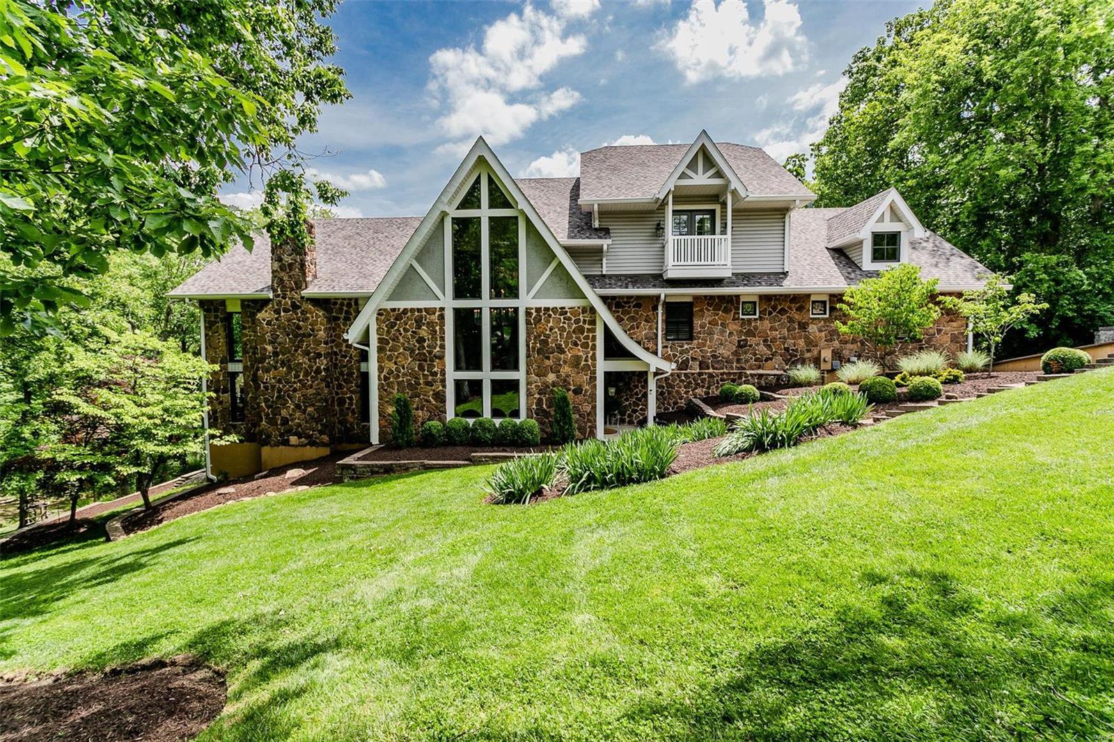 Incredible custom residence w/an extremely private setting located on 2+ acres with luxurious pool, extensive landscaping & 4 car garage. This 5 bed 6 bath home has so much to offer! Beautifully updated eat-in chefs kitchen w/sub zero, wolf range, double wall ovens, large breakfast bar, & comfortable gas fireplace. Open to spectacular vaulted-ceiling great room w/gorgeous wall of windows, large stone fireplace & wet-bar. Impressive foyer spiral staircase leading up to gorgeous master suite featuring his/hers walk in closets, private sitting area, w/private balcony overlooking backyard, & large master bath. Upstairs has 4 additional bedrooms each w/private bathrooms, & laundry room. Custom lockers, lovely finished lower level, & 1000 bottle wine cellar. Enjoy your summer on the expansive deck with pergola & fireplace overlooking salt water pool and secluded wooded lot. Additional lower level with plenty of storage & work out room.  All of this in desirable Sunset Hill & easy HWY access. Additional Rooms: Wine Cellar