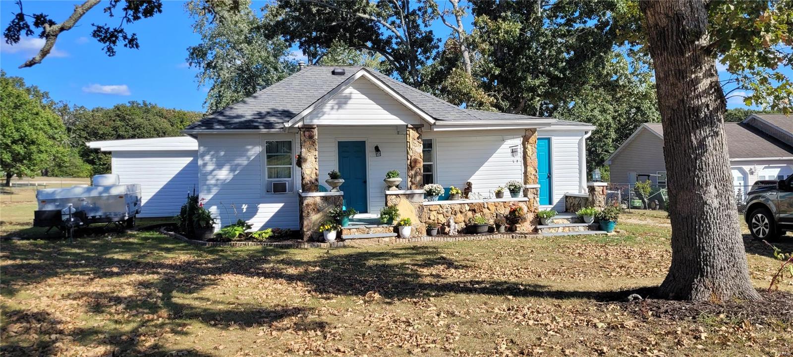 Rustic 3 bedroom home with over 1/2 acre of land.  Home has been remodeled inside with some new flooring in kitchen and living room.  Updated kitchen cabinets and both bathrooms have been updated also.  Large fenced back yard with just enough trees for that summer shade.  Large covered front porch for those evenings to just relax.  Come take a look!  You will love it!
