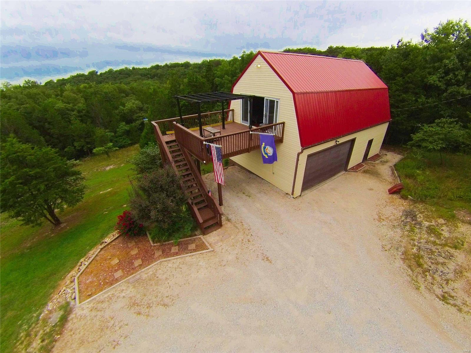 Welcome Home to almost 4 acres of beautiful views & privacy! Home is very unique style but very spacious open floor plan. Home features 2 bed, 1 bath with gorgeous hardwood floors on main floor, spacious kitchen with pantry, beautiful built -in bookshelves surrounding an electric fireplace and a full wall of glass door to over your picture perfect acres. Main bathroom has a large walk in glass and tiled shower and walls with a linen closet. Lets not forget the 2 car attached oversized garage with heating and cooling too. This home is in Festus School district!! The possibilities of this home and acres will amaze you, take a tour today!
