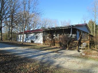 Tons of room in this 3bdrm/1ba home on 23 acres with small pond & shop.   Sellers have recently installed new flooring & done some upgrades.  Home has an open floor plan feel with eat in kitchen, dining rm and lrg living rm with wood stove.  Bonus room can be used as a den/office or additional sleeping rm.  There is a utility rm off the back side of the home with ramp access in case stairs might be an issue.  The shop was once used as a business and has a heated office area.  Property also features an abundance of wildlife with deer stands and a stocked pond and even a small fenced in area for pets.  Conveniently located just a few miles off Hwy 50.