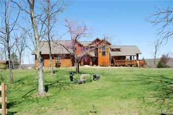 252 acres m/l of Seclusion & comfort rolled into one. Everything about this property, from the rolling pastures, to the winding creek, to the beautiful 4600 sq ft rustic 2 story home speaks of elegance. Let the world melt away on your leisurely drive down your mile long driveway through woods & pastures to be greeted by a stunningly gorgeous home. As you enter your front door, the wood walls and ceiling and the stone looking tile and wood floors gives you the feeling of true country living at its best. The home has everything you could want with 5 bedrooms, 3 1/2 baths, a large stone wood burning fireplace, a full walkout basement and covered wraparound decks. The property is bordered by a mile m/l of winding creek & is fenced and cross fenced and ready for your cattle with ponds and auto waterers. As a bonus there is a new under roof 2 bedroom 2 bath home and a well, electric and lagoon for an additional home or camper.