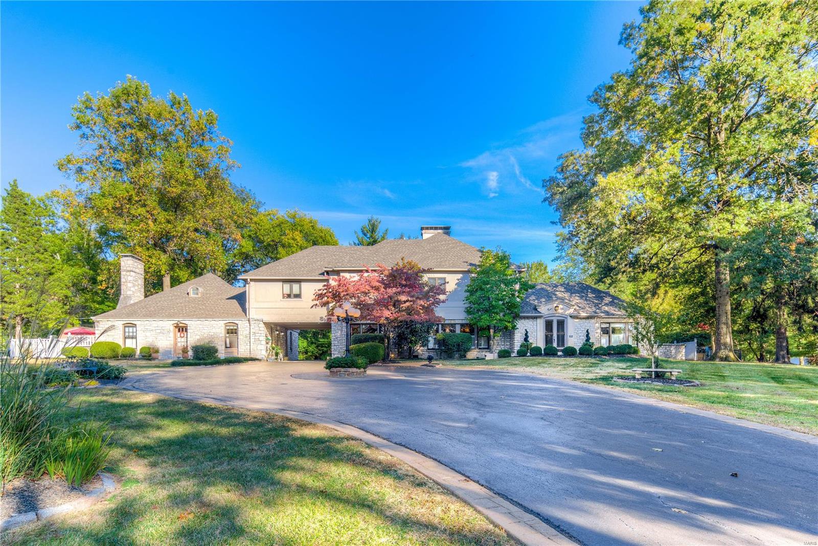 POOL'S OPEN-READY TO ENJOY! 1ST FLOOR BEDROOM - Actually 2 masters. Live with today's amenities in heart of Town and Country. Stone and stucco manse on 1.68 acres. Enter into the domed ceiling foyer. Elegant 21X18 dining rm highlighted by limestone fireplace. French doors open in to a light & airy great room. Exceptionally large kitchen w. limestone floor, glazed custom cabinetry, honed granite countertops & commercial grade appliances. Butlers pantry is off the sun-lit breakfast rm w. bay window. Spacious master bedroom suite with lavish bath, jetted tub and 2 add'l bedrooms with Jack n' Jill bath. Convenient 2nd fl. laundry rm serves the main home and guest house. Private outdoor living area includes heated Pebbletec finish pool with lighted stone waterfall surrounded by mature landscape & flora.Attached guest house has fenced patio & is ideal for in-law, au pair, teenagers includes; Living rm, Dining rm, kitchen, bedroom, plus 1 & 1/2 baths. Generator incl, oversized 3 car gar.