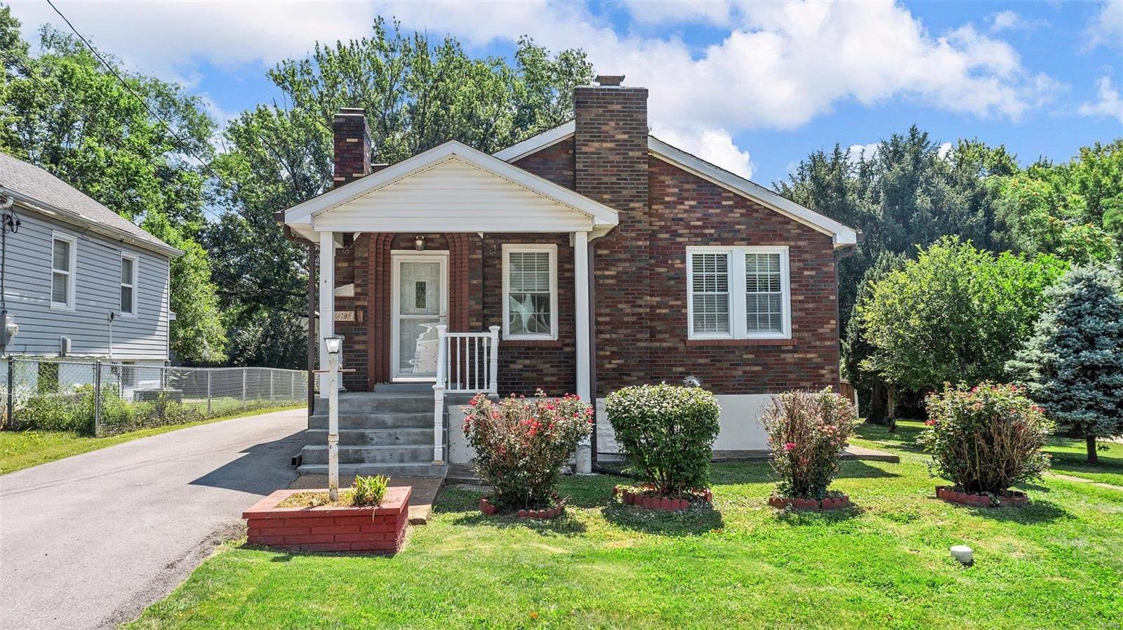 Stop the car to view this charming cottage featuring a bright & open floor plan with beautiful hardwood floors throughout. The living room has a cozy feel with an exposed brick wall with custom built shelving and a brick fireplace. You'll love the spacious eat in kitchen with white cabinets & appliances and black/white tile giving the room a fresh look. In the morning step out onto the screened in porch to enjoy your coffee overlooking the peaceful backyard setting. The primary bedroom and 1 additional bedroom feature plenty of closet space and a full bath located on the main level. The lower level boasts a large rec room showcasing another fireplace with a brick hearth, a bonus room, half bath, several closets and another spacious room just waiting for you to create the perfect space to fit your family's needs. Enjoy the level backyard overlooking the tree lined property featuring both a 1 car and 2 car garage. Schedule your showing today because this unique property won't last long!