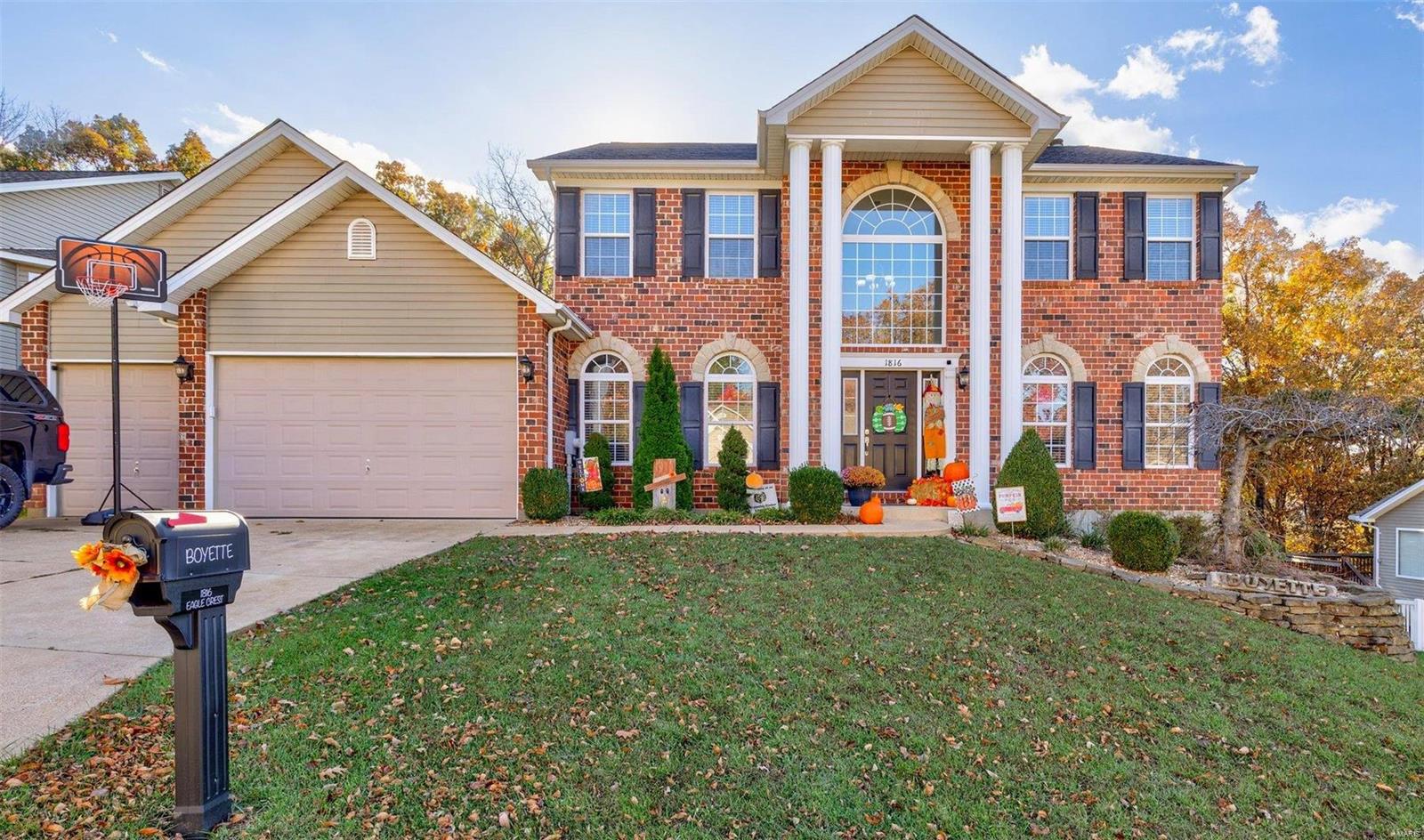 Don't miss this Former Display home offering many upgrades including 9ft ceilings throughout! Gorgeous 2 story with beautiful stone/brick front is in a very convenient location. Large open entry is light and bright with a T-staircase and balcony to the 2nd story and to the main floor family room. Beautiful hardwood floors throughout main level in the separate dining rm, living rm, family rm, and kitchen areas. Kitchen offers SS Appl. and is open to the large Breakfast area w/door leading to your private deck. Large bay and fireplace in family room. Main floor laundry room just off the 3 car garage. 2nd floor offers a oversized master w/ 2 closets & ensuite. 3 additional bedrooms & full bathroom complete the second floor. Lower level has a 9ft pour & finished living space w/a full custom bath, recreational area, office space, storage and media/gaming area for all your family needs. The walkout leads to the great outdoor patio and fenced yard, backing to woods for your private oasis.