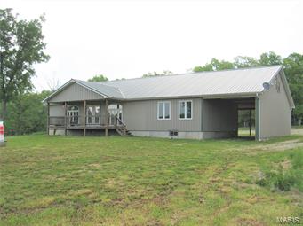 This property is a horse lovers dream come true.  Modern barn type two bedroom, two bath ranch home with everything for the horse enthusiast.  The footprint of the custom built home encompasses 3700 sq ft with 2050 sq ft of living space with all the modern amenities including custom built oak cabinets throughout the home.  Full master bedroom suite with huge walk-in closet, even the second bedroom comes with a huge walk-in closet, gas fireplace and a massive 13'x16' bath and laundry room.  The main structure has two 10'x12' stalls with water, a 15'x50' garage to park the truck and trailer while attached, additional parking and a large 12'x19' separate secure tack room. The horse ranch consists of 8 acres m/l divided up in four paddocks with everything one would need for horses, including outside water hydrants, dump station, a 37'x47' hay and storage barn, a 32'x68' barn with additional horse stalls, electric and water hydrant.  The land is mostly open pasture and has two ponds.