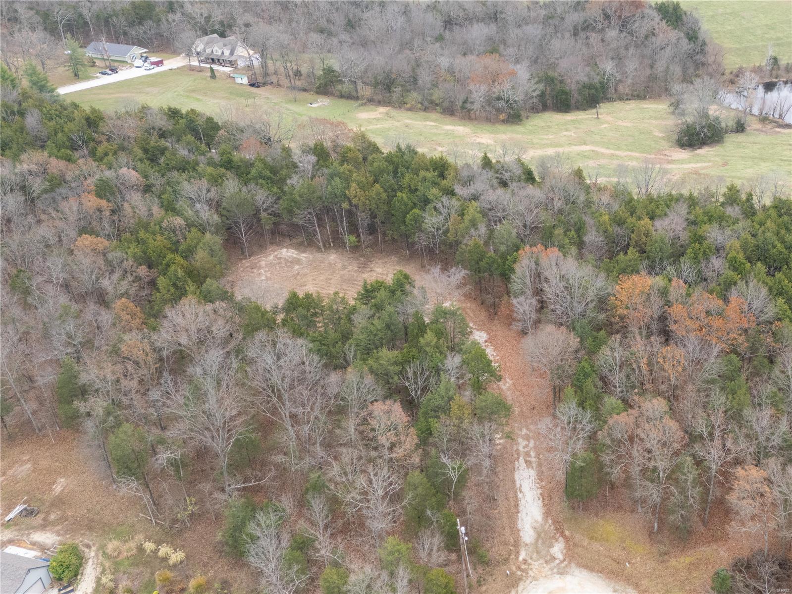 Nestled at the end of a peaceful cul-de-sac, this stunning 5.45-acre lot offers the perfect combination of seclusion and accessibility. Located just 10 minutes from shopping and amenities in Festus, it’s an ideal retreat without sacrificing convenience. The heavily wooded acreage provides a serene backdrop, while approximately 1 acre is already cleared, ready for the construction of your dream home. Enjoy the beauty of nature and the privacy of a quiet, tucked-away location. County water is available with the installation of a water district connection at the meter. This is your chance to build the home you've always envisioned in a breathtaking setting. Don't miss this rare opportunity—your dream property awaits!
