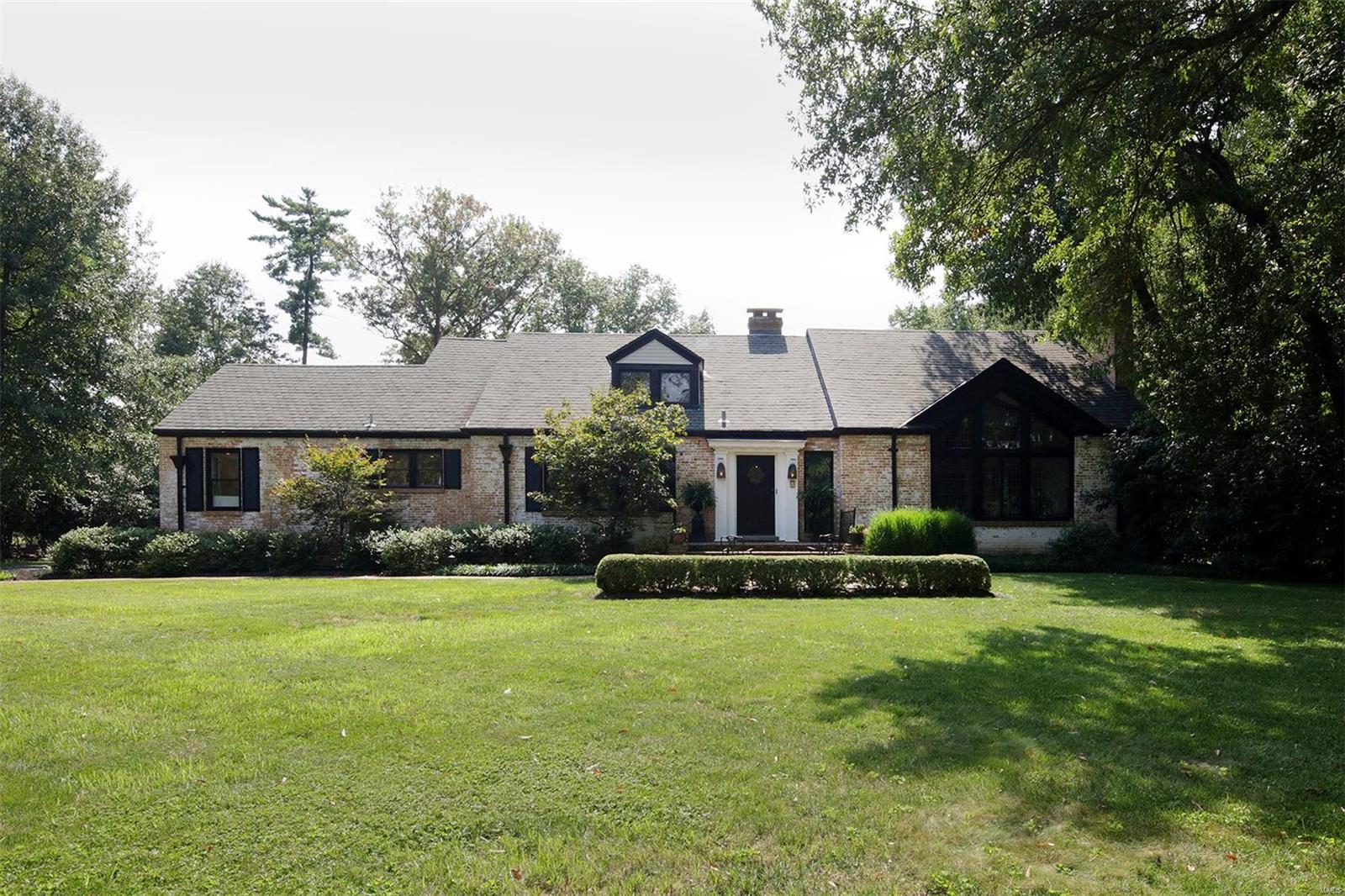 This stylish Ladue 1.5 story home situated on 1.65 acres and in a fabulous location.  The living room features a picturesque vaulted & beamed ceiling, a breathtaking leaded glass window, a stone fireplace, wood floors, & dramatic chandelier.  The large dining room leads into the newly updated eat in kitchen & hearth room.  In addition the main floor has a very emotional family room for additional living space with a 2nd main floor half bath.  The master suite is over the top with a gas fireplace as the focal point of the room.  The brand new master bathroom is exquisite with a separate shower & claw foot tub, double vanities, refrigerator, huge professionally finished closet with built in ironing board.  The 3 additional bedrooms are a very nice size.  The lower level has a nice rec room.  The premier level lot is appealing & private.  The new pool is a perfect addition & finishes off the backyard beautifully.  Lovely lighting throughout & so much charm!  Don't miss this special home.