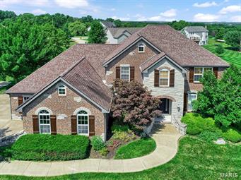 STUNNING!!! This 1.5 story offers a terrific floor plan. The impressive entry opens to a lovely formal dining room w\elegant crown molding. The main floor boasts beautifully done maple wood floors. The living rm has a gorgeous stone FP. The spacious kitchen has plenty of cabinet space, a large center island breakfast bar, large pantry & upgraded stainless appliances. The main floor master suite has tray ceilings, bay window, an enormous walk in closet. The master bath is luxurious with dble sinks, make up vanity, newly finished tile shower. The upper level offer 3 nice sized bedrooms with all walk-in closets. The lower level is AMAZING, it offers plenty of room for entertaining w/a huge rec room, a wet bar with granite counter tops, office (could be a bdrm), exercise room & storage rm (well hidden). The outside has plenty of level play area, covered deck, stamped patio, sprinkler system. COOL: 14 SEER+