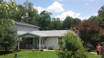 Nice home with over 2400 SF of living space. Partially finished basement with walkout. 5 bedroom 4 1/2 bath home with possible extra bedroom in basement. Tons of space with this open floor plan! Home overlooks wooded landscaped 2.33 acres with above ground pool and deck! Detached 26 x 52' shop/ garage with possible chicken coup/ dog kennel built in. Home has wood heat in the basement that plumbs directly into to central air handler- cutting down on heating costs! Great spot to live close to the lake, 17 miles from Farmington, 10 minutes from I-55 make for a private, quick commute location!