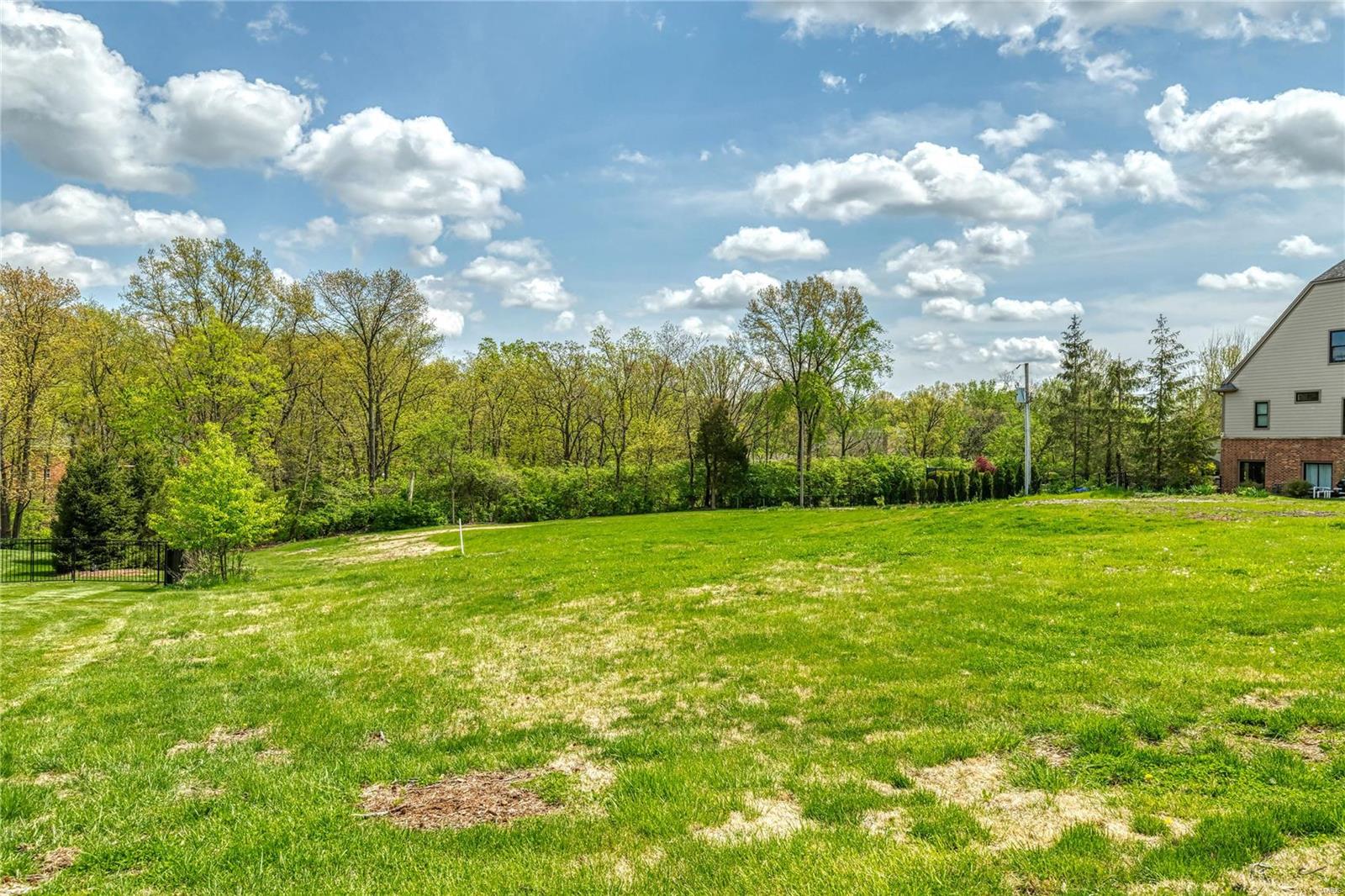 Your opportunity to own your lot and choose your builder. Beautiful partial walkout or full walkout lot ready for your new home.
Lot is vacant, former home and swimming pool have been removed. Please drive by and walk the lot at will. Oak Springs is a very
desirable lane with predominately new homes. 2 homes presently under construction are sold. Home faces west, so afternoon shade in the backyard. Perfect for the pool and patio you have planned for. So convenient to major highways 40/64,270,141 and most hospitals, shopping, restaurants (Mason Woods Village) and Town Center, Longview and Drace Park. The good lots go fast, so act fast. Additional Rooms: In Platted Subdv.