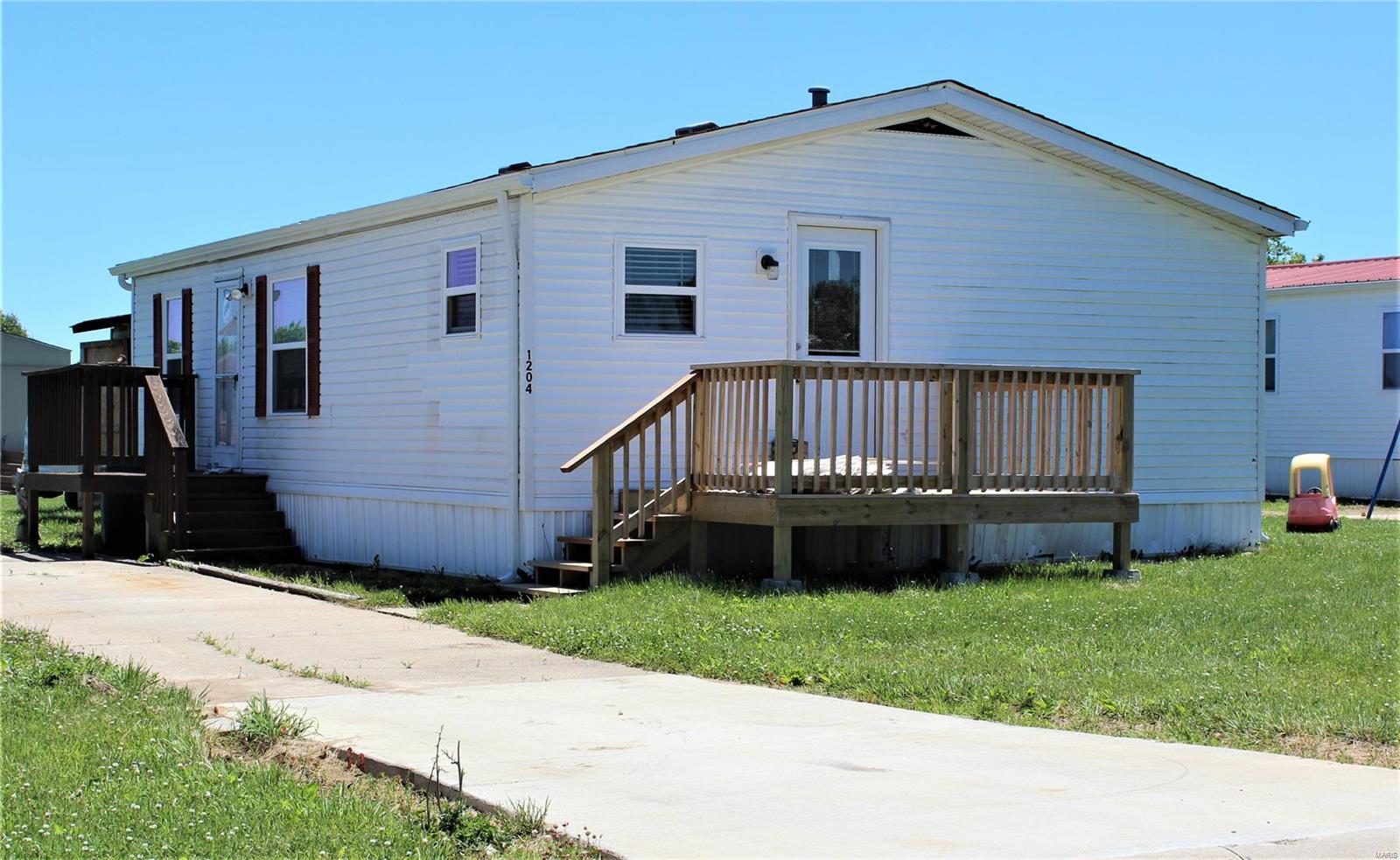 *No showings till 8/29**Nice updated open floor plan double wide home with front deck just off the kitchen. Once inside you will find kitchen with newer cabinets and counters, nice breakfast bar, some newer appliances, dishwasher, microwave, smooth top stove/oven and refrigerator all to stay. The laundry room has newer vinyl plank flooring as does the kitchen and full bath. All carpet flooring in living room and all the 3 bedrooms. Newer light fixtures throughout home. The owner pays pad rent, taxes, monthly fees.  This is a no smoking and no pet property. Applications available online at company website, pay $30 fee for all persons 18 and over living in the property. You can upload a copy of your state issued picture ID and proof of income on the application.