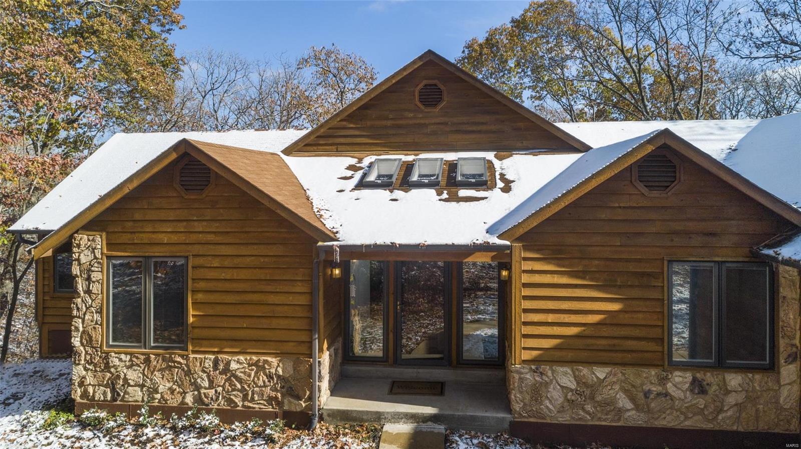 This gorgeous ranch is located in 3.15 acres. Only a 10 minute drive from the shopping/schools, this home features a spacious open entry with skylights. Plenty of natural light throughout this home. Walk into the great room with a wood burning fireplace and large windows that feature the serene view of the surrounding trees. The dining room lies right off the great room. Newly redone kitchen boasts white cabinets and plenty of counter space with a combined breakfast nook surrounded by large floor to ceiling windows. A large 2 car garage has plenty of room for additional storage. 3 bedrooms are located on the main floor, including the master which has a large jetted tub and separate screened in porch for a quiet morning coffee. A large walk-in closet in the master has ample space for storage. The basement features a large recreational area with a full bathroom and 4th bedroom/office. A cozy corner makes for the perfect den, while the work bench in the storage area is great for projects.