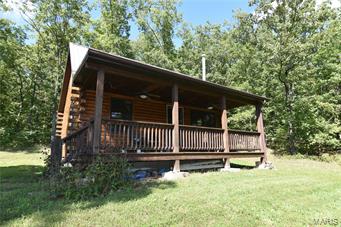 Attention hunters! Scenic 40 acres of wooded property with a rustic log cabin that overlooks a stocked 1 ½ acre pond. This tranquil retreat is a great space to get away from the Hussle and bustle of town life and relax. The log home is finished with tongue and groove walls and wood floors, warm woodstove provides heat during the cold winter days. Cabin has one bedroom and a loft. Located only an hour South of St Louis and 10 mins from Farmington, you’ll love being in the country but only a few short mins from restaurants and shopping.
