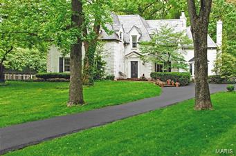 Enjoy the gracious charm on an "east coast house" in the heart of a premier Ladue neighborhood.  Not visible from the road, as you drive over the bridge the serene setting on 2 very private acres makes your worries float away.  The house has 4 bedrooms, 4.5 baths, kitchen/hearth room with marble counters, family room, living room, dining room, upstairs laundry, finished lower level, 5 fireplaces and a pool.  This is a home for refined buyer. Seller to exclude living room drapes and curtain rods. Additional Rooms: Sun Room