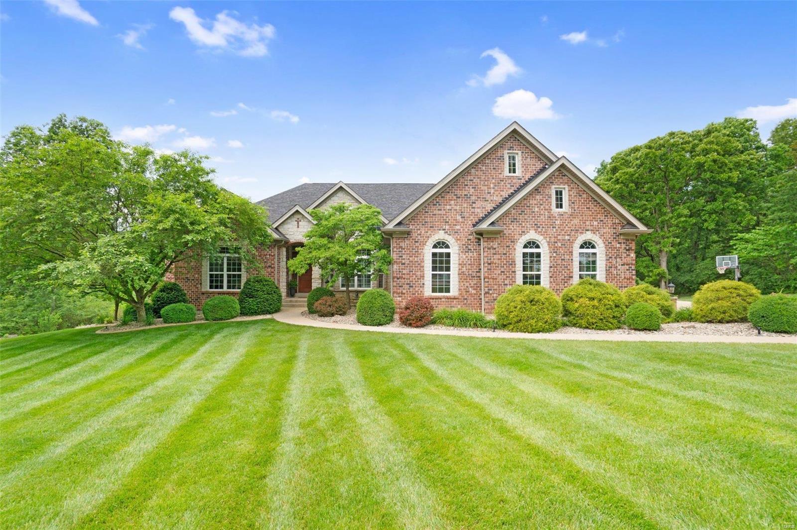 Welcome to your dream home! This stunning property offers a spacious 6,811 sqft of luxurious living space nestled on 5 pristine acres. With 5 bedrooms, 3 on the main floor & 2 in the lower, & 4.5 bathrooms there's ample space for everyone. 

An impressive open-concept layout with hardwood floors throughout, elegant 12-foot decorative ceilings, & three fireplaces; but the heart of the home is in the kitchen! Featuring granite countertops, custom tile backsplash, a walk-in pantry, SS appliances, and a separate dining room. As you descending to the lower level the entertainment options abound with a second kitchen, theater room, and a pool. Don't forget the oversized garage, ample storage space, and an additional laundry room in the basement all for added convenience. 

Relax in the screened-in porch or take in the breathtaking views from the walk-out basement. This home blends elegance, comfort, & functionality —schedule your showing today & experience luxury living at its finest!