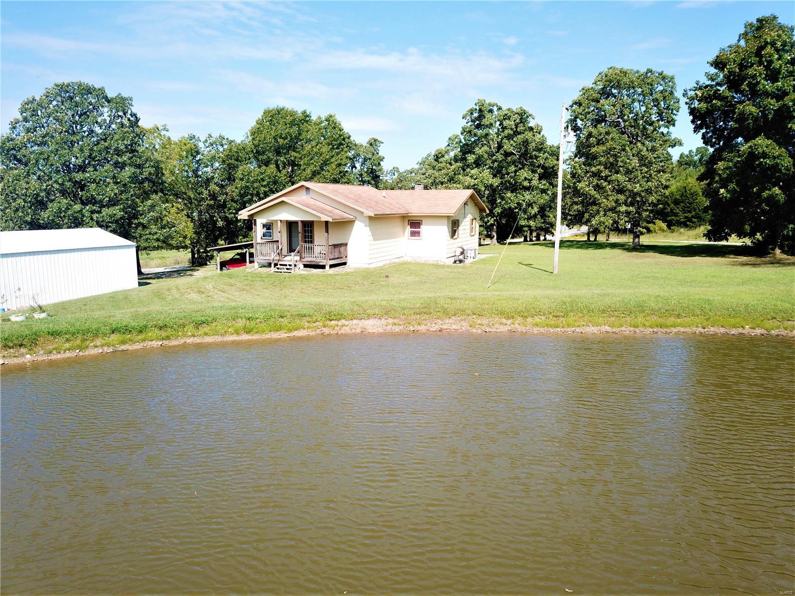 Just minutes from Crocker limits right off State Highway BB is a 3 bed 1 bath home  that has had an updated kitchen and dining room. Home sits on a full basement with garage. This home sits on 3.1 acres with a 42x30 detached garage and a half acre stocked pond. Mature live oak and walnut trees line the yard and provide ample shade. Outdoor wood furnace with with boiler will keep you warm and cozy all winter. Home is wired and comes with a 7 camera surveillance system. Also an additional two car carport attached to the house. This home needs a little updating but its very well built and has been well maintained.  Additional bathroom is roughed in downstairs and could be finished out fairly easily.