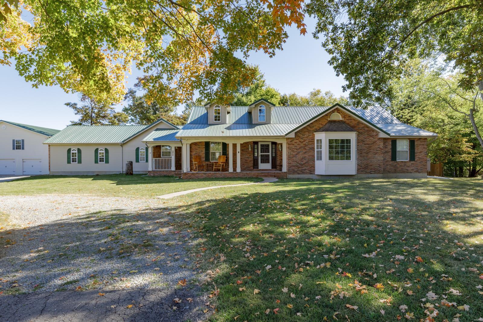 Endless Opportunities with this secluded home on 3 acres! Just outside of Farmington you will find the most Spacious of living at desired levels. Over 3500 sq ft on the main level of this Ranch with full unfinished basement with walk-out (Garage Bay). On this gorgeous patch of curb appeal, you will be attracted immediately with the circle drive and mature trees. This home is practical and has endless potential for an array of living styles designed for you.  This 40 x 60 detached 3 Bay 2 story garage even has the completion of drywall all through-out the upstairs.  You will spend more time outside enjoying the tour of the secluded backyard with large patio and scalloped privacy fence.  Enter the Formal Entry with Formal Dining into vaulted ceilings in the living room along with gas fireplace.  Nice wood floors and open stairwell! Enjoy your kitchen everyday featuring center island, bar area, breakfast area, and work area/coffee bar/Central Vac & Spacious main floor laundry with window.