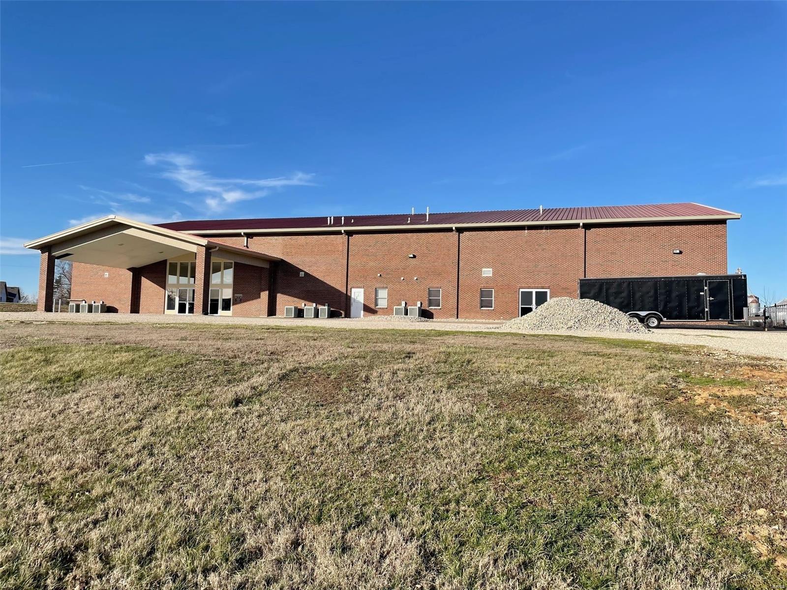 This 16,550 steel, clear span construction building on 4.5 acres is currently being used as a church, but its possible uses are many -- an education facility, corporate headquarters, or wedding venue to name just a few.  Six classrooms/private offices and newly remodeled public restrooms surround the sanctuary/worship center, which could be used for large meetings or corporate events.  Several other larger classrooms, meeting rooms, offices, and additional restrooms make up the east wing, along with a large kitchen being constructed with front and back of house setups, a loft/balcony under construction, and gymnasium/event center with two sets of double doors. Location: City, Industrial Area