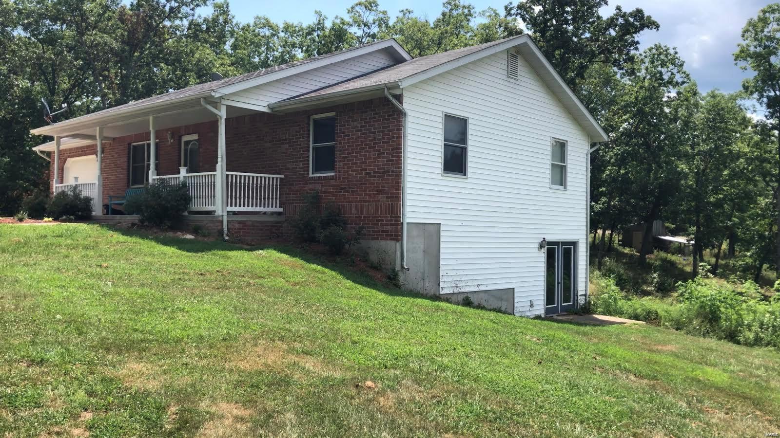 Licensee assisting seller is related to seller. This well kept, brick front, ranch style home is waiting for it's new owner.  That should be you! Home has an open floor plan and a full basement.  Basement has a concrete suspended floor under the garage that will protect you from severe weather. This property includes two parcels (two tax IDs) that will give you 6 acres m/l to enjoy! You can sit and relax on the back deck or the lower patio and enjoy wild life. You will also have access to a catfish pond and picnic area with a covered patio in the subdivision.  $200 per year subdivision dues/association fee that includes a community trash dumpster and road maintenance. Private setting yet close to Highway 28!
Lot 16 is 3.32 acres Tax ID 16-5.0-16-000-000-018.030
Lot 18 is 3.32 acres Tax ID 16-5.0-16-000-000-018.000