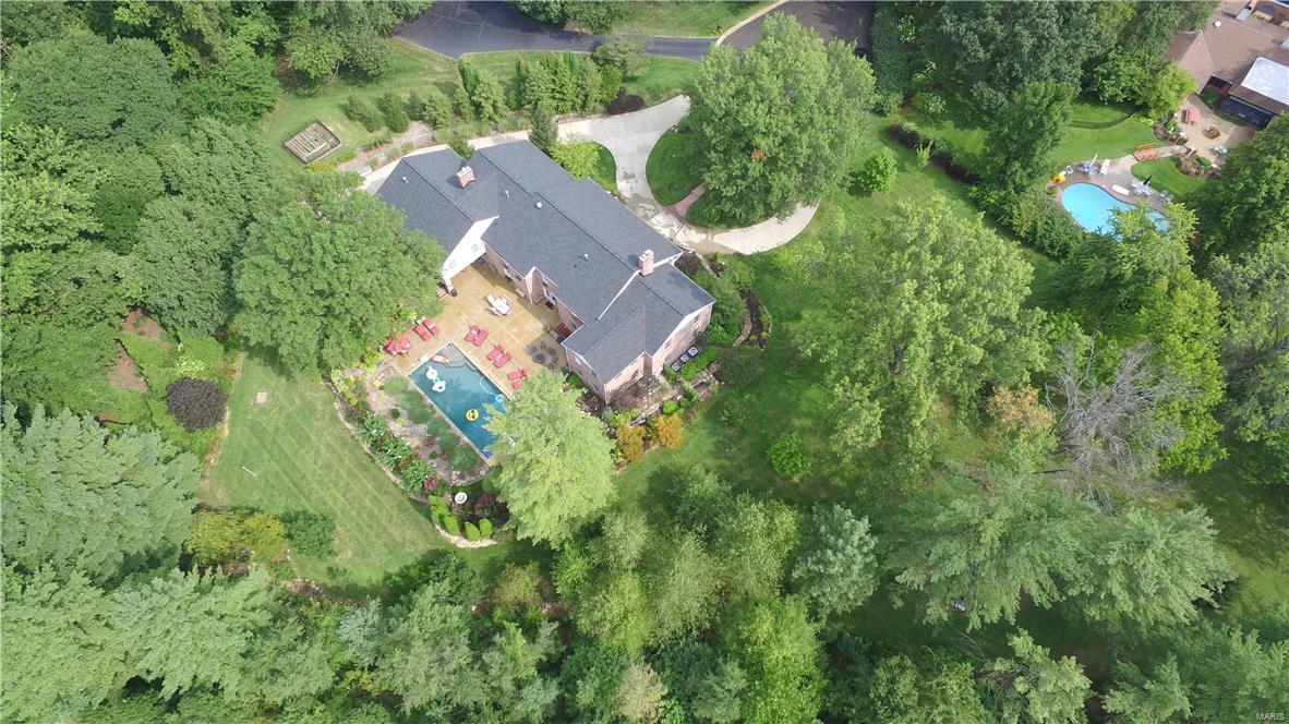 Magnificent very private 6 bed 4.3 bath estate on 1.7 acres in prestigious Bellerive Country Club Grounds. This home offers custom finishes at every turn.  Features include a living room with fireplace, a large family room, exercise room and a formal dining room complete with a butlers pantry. The kitchen is a chefs dream complete with high end appliances, granite counters, custom cabinets with an attached hearth room with a gas fireplace leading to a covered patio overlooking the gorgeous pool. This home offers a front and back staircase, LETS NOT FORGET THE ELEVATOR and laundry on all 3 floors!! Upstairs you will find the 20x26 master bedroom suite with spa like bath. the upstairs is complete with an additional 5 large bedrooms and 3 additional full baths and an abundance of closets. The backyard is a private gorgeous oasis with a resort setting and pool.  This home is the lifestyle you have been waiting for!! This home is fully handicap accessible. Some Accessible Features