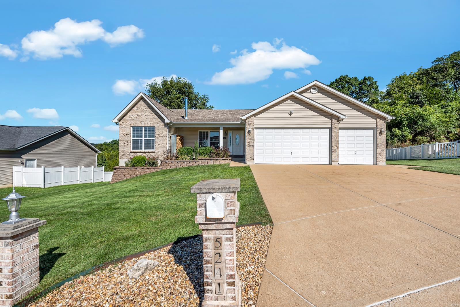 Remarkably maintained ranch in the Crossings community! This home features a lengthy list of upgrades & A+ curb appeal w/brick front, 3-car garage & covered porch. Walk in to a wide open floorplan w/wood floors, neutral paints, custom moldings & tons of natural light. Family room includes a custom wood burning stove accented w/timber mantle & accent wall. Gourmet kitchen offers a large center island, custom backsplash, SS appliances, dining area & tile floors. Main floor MB suite has crown moldings, walk in closet & large MB w/dual vanities, jetted tub & separate shower. 2 add. BR's on the main level share a 2nd full bath. Walk down a lighted stairway to a finished LL that doubles as a separate living quarters. You'll find a full kitchen, walk-out access, rec room, 3rd bath, 4th BR & tons of storage space. Out back is a custom deck w/full brick pillars w/lighted accents, steel pergola & usable backyard. Garage is further improved w/heater, enlarged 3rd bay, sub panel & sealed floor.